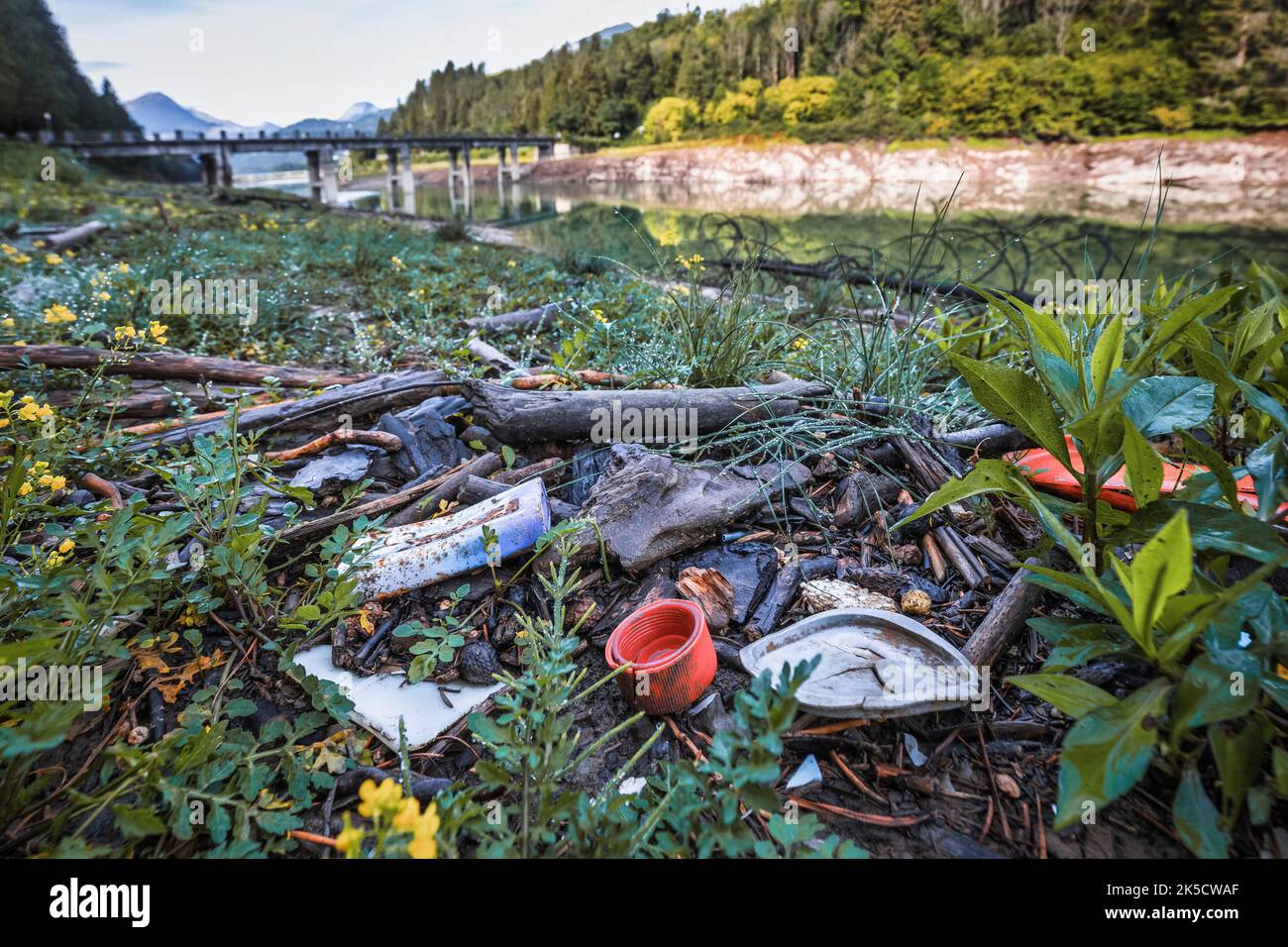 Italia, Veneto, provincia di Belluno, Lago del Centro Cadore. L'inquinamento ambientale da rifiuti e plastica è emerso con il ritiro dell'acqua dal lago Foto Stock
