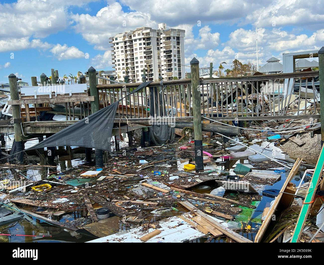 Le foto mostrano le barche danneggiate dei gamberetti e i detriti nel periodo successivo all'uragano Ian a Fort Myers. L'uragano Ian ha lasciato questo porticciolo di Fort Myers distrutto, con le barche che girano intorno e i moli pesantemente danneggiati. Foto Stock