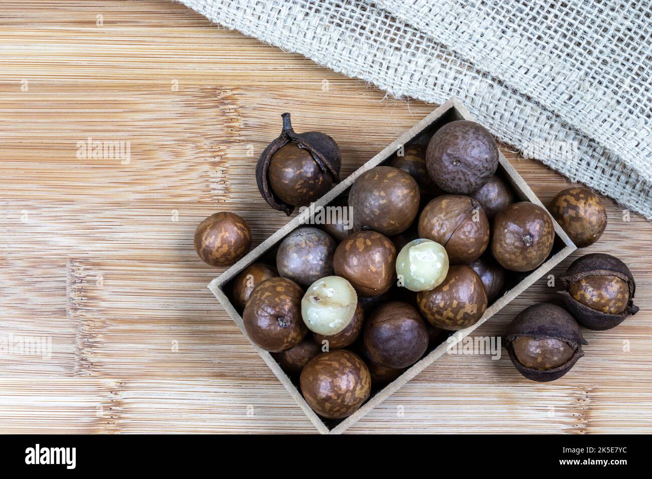 Primo piano della noce macadamia con focalizzazione selettiva sulla tavola di legno in Brasile Foto Stock