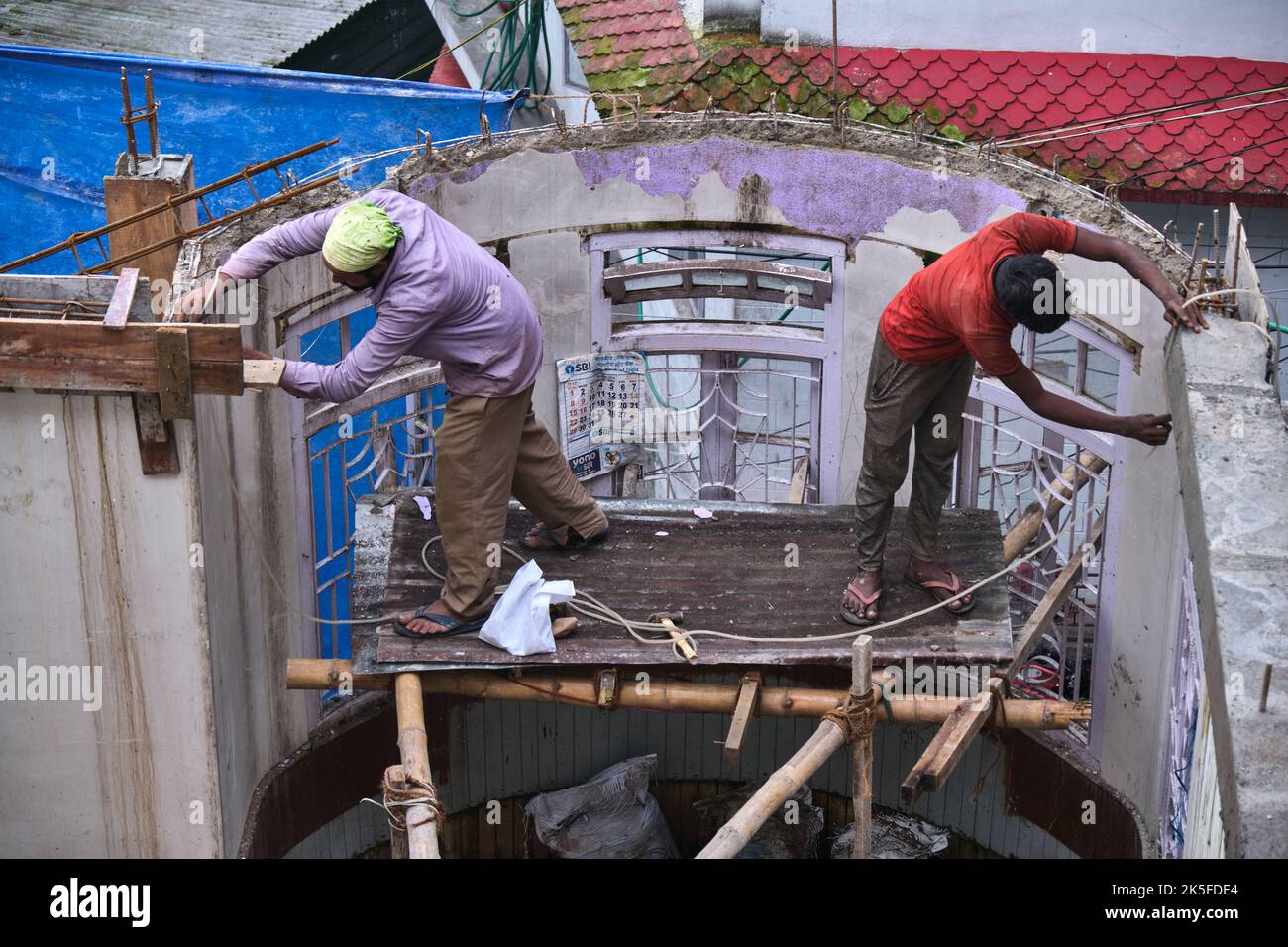 22 Giugno 2022, Darjeeling, India, lavoratore di costruzione indefinito che costruisce o costruisce il muro mettendo mattoni e cemento in darjeeling, India - conce Foto Stock