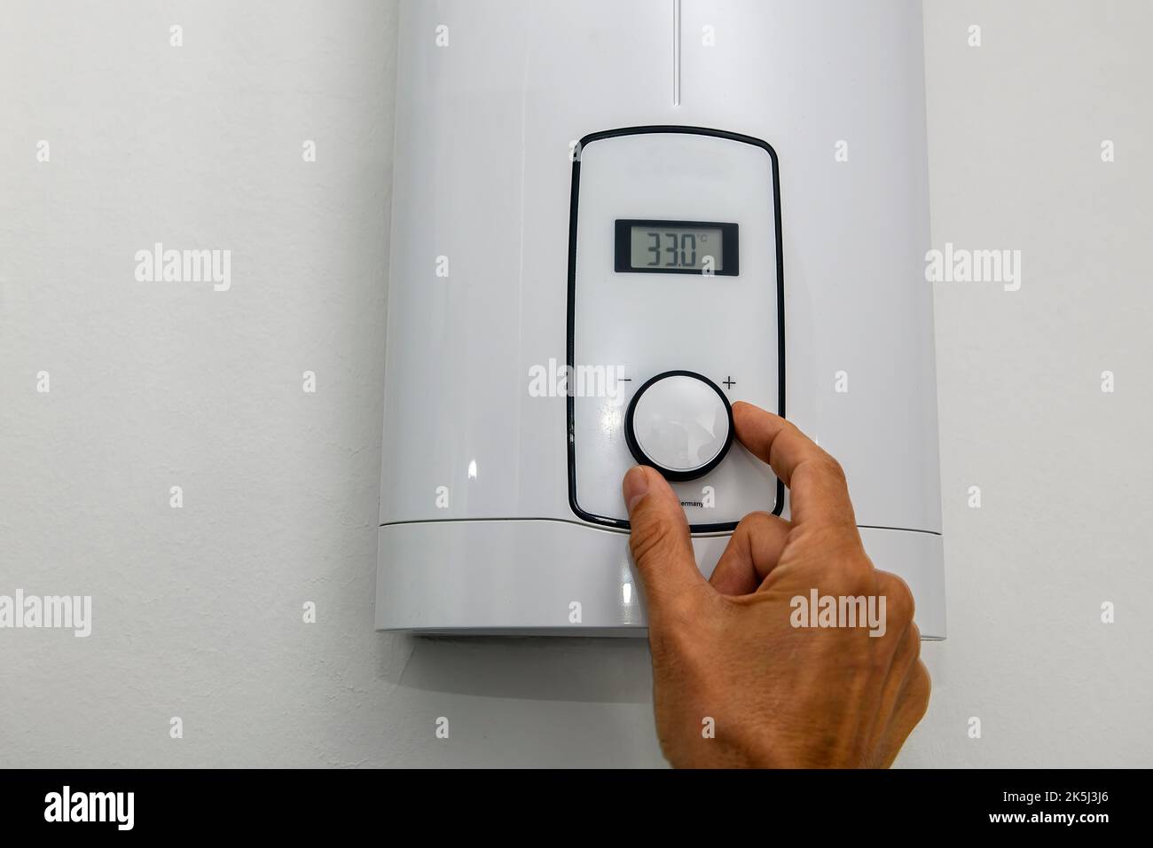 Scaldabagno istantaneo per acqua calda doccia per doccia il bidet lavabo è impostato a basso livello energetico 33 gradi Celsius per risparmiare energia Foto Stock Scaldabagno istantaneo per acqua calda doccia per doccia il bidet lavabo è impostato a basso livello energetico 33 gradi Celsius per risparmiare energia Foto Stock