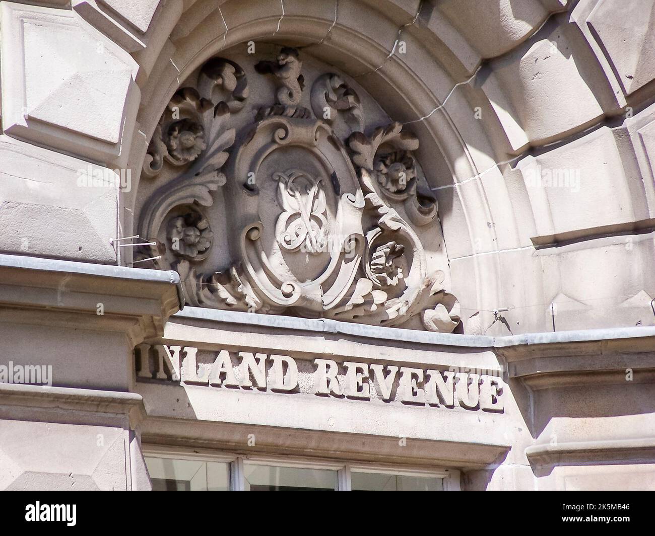 Pietra scolpita sopra l'ingresso di un ufficio fiscale del governo britannico Inland Revenue. Foto Stock