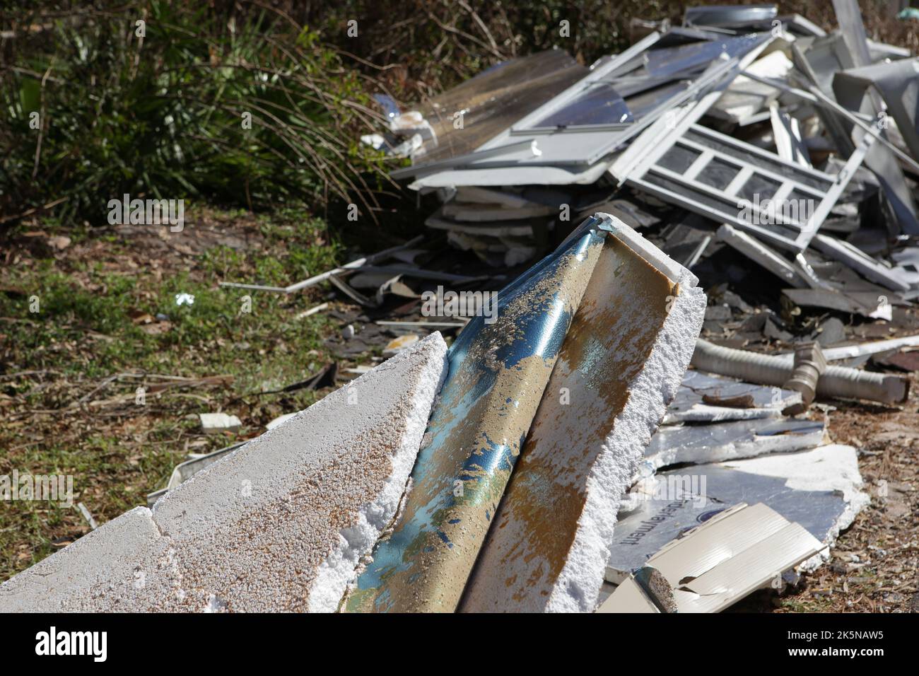 Detriti dalle case distrutte dall'uragano Ian giace lungo il lato della strada in attesa di pick up a North Fort Myers, Florida, 8 ottobre 2022, © Katharine Andriotis Foto Stock