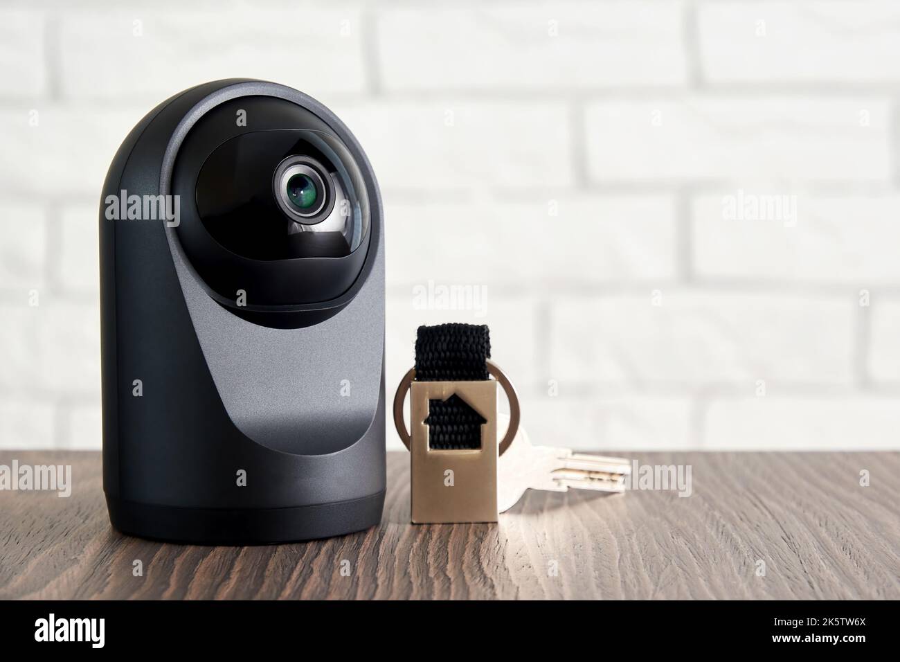Telecamera IP e tasti porta tradizionali sul tavolo. Concetto di protezione domestica wireless e controllo della sicurezza. CCTV Foto Stock