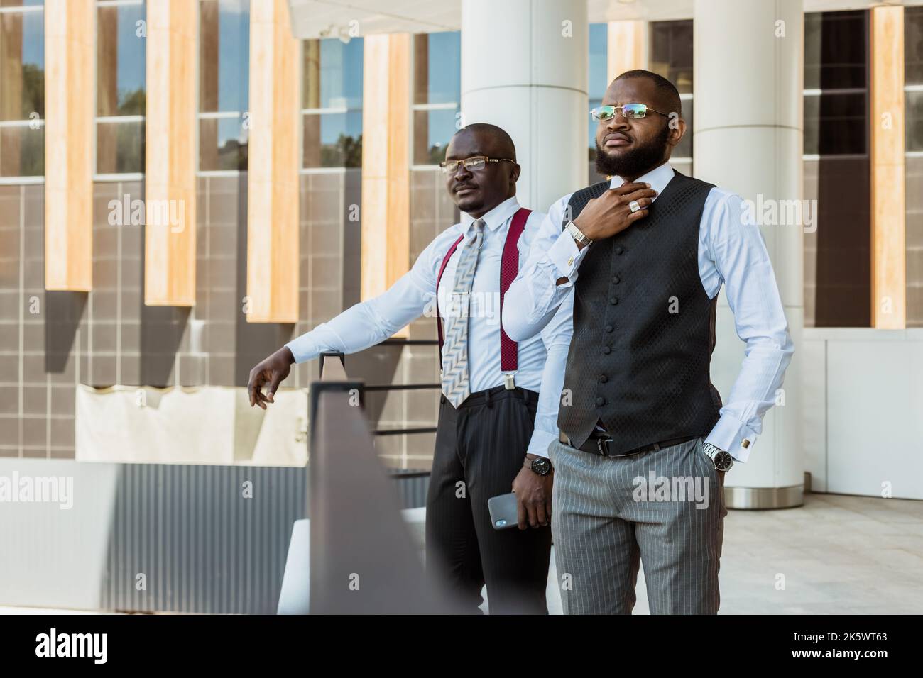 Ritratto di due uomini d'affari dalla pelle scura che parlano sullo sfondo di un moderno edificio esterno. Meeting all'aperto Foto Stock