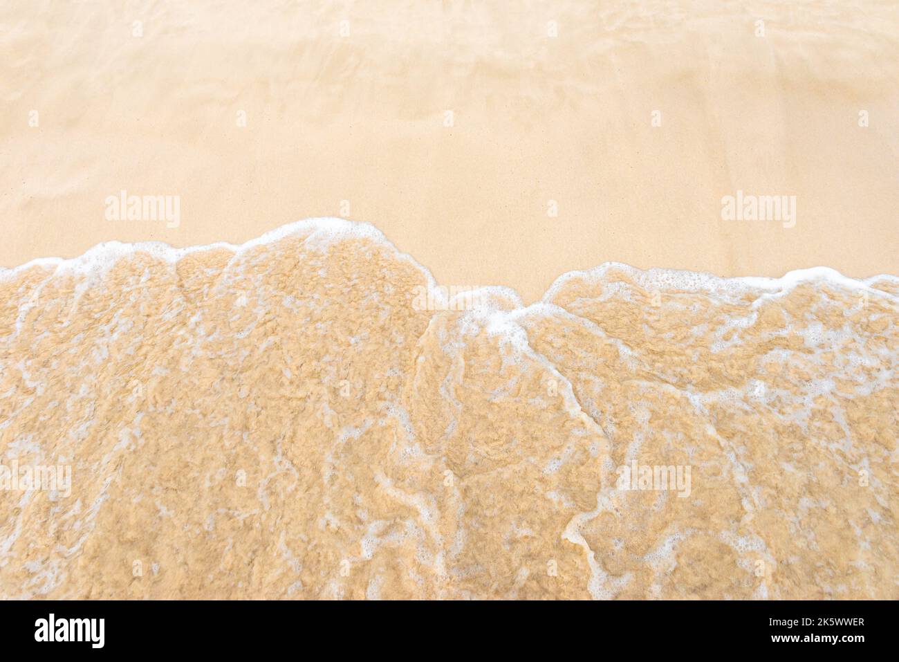 Snady Shore soffice onde che sfondano il mare tropicale sopra la schiuma vista Foto Stock