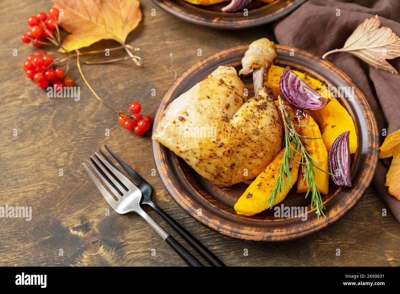 Cena del Ringraziamento fatta in casa zucca matura e tacchino del Ringraziamento su un tavolo di legno scuro. Foto Stock