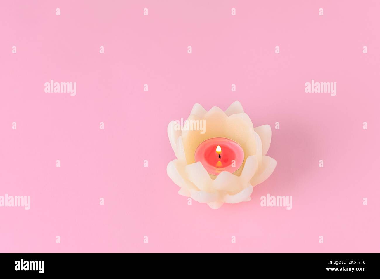 Candela di loto su sfondo rosa tenue con spazio copia, mockup Foto Stock