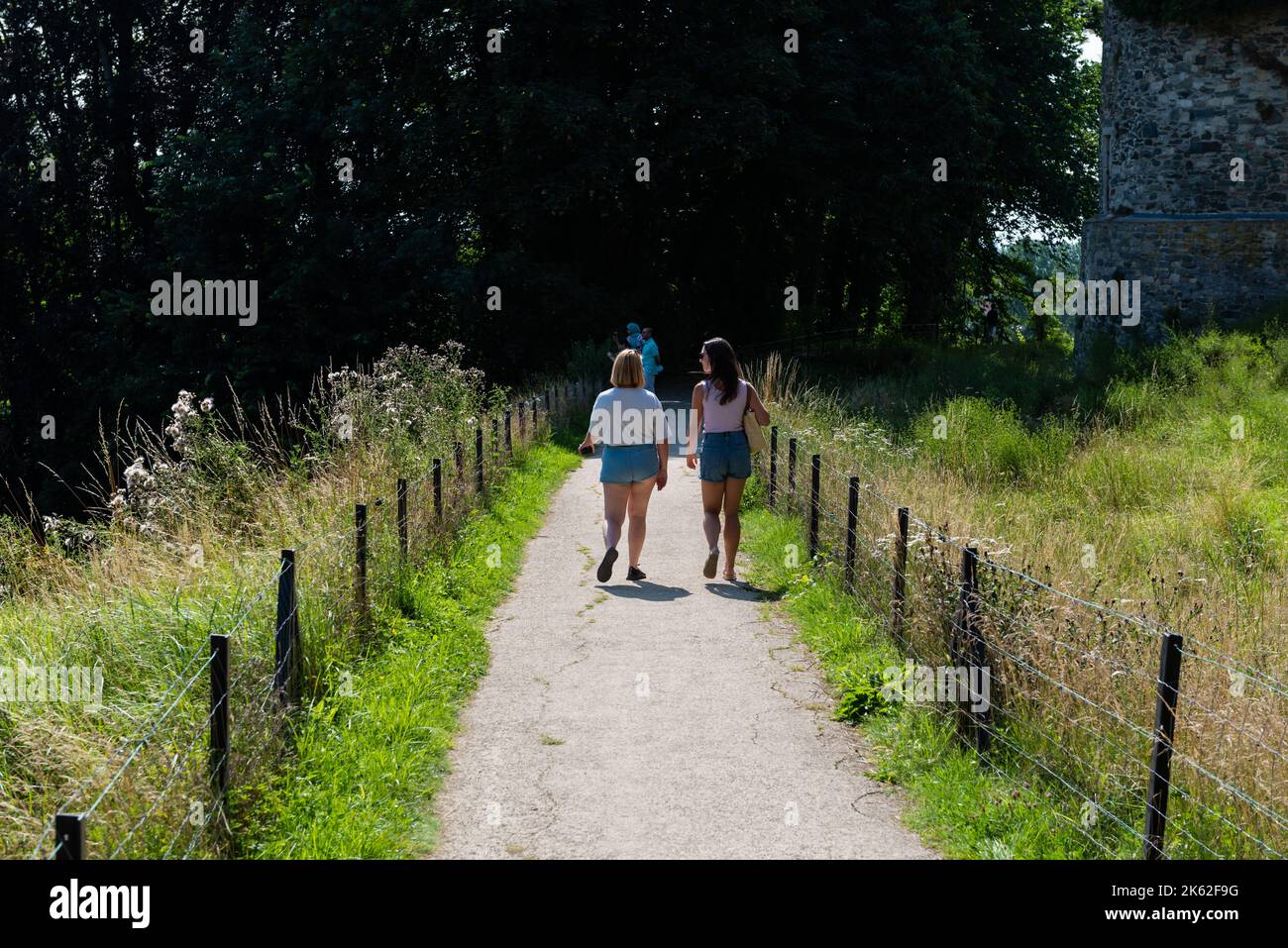 Lennik, Regione del Brabante Fiammingo, Belgio - 07 20 2021 due giovani amiche camminano in un parco Foto Stock