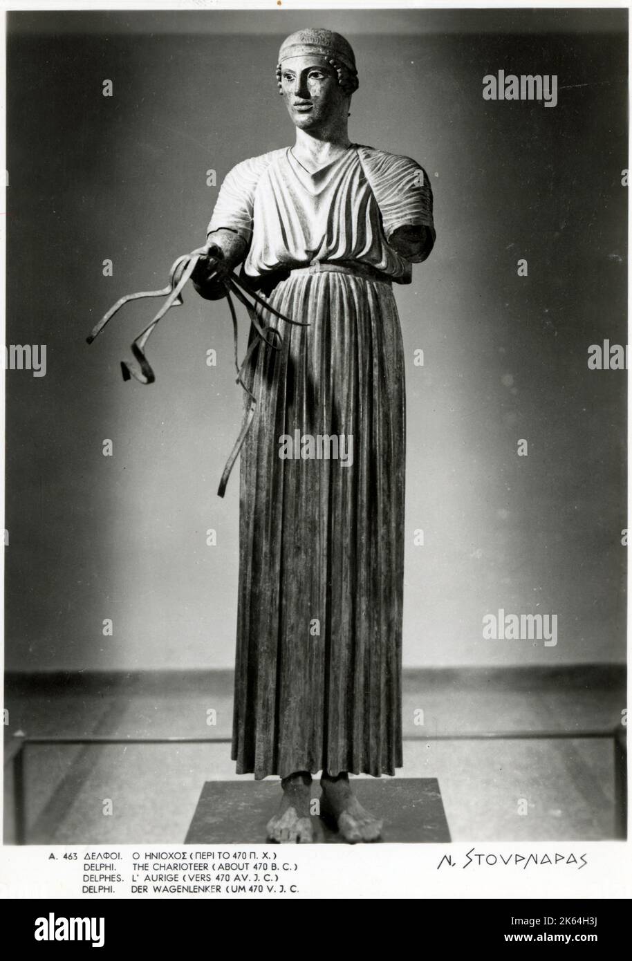 Statua in bronzo dell'auriga (470 a.C. circa) - Delfi, Grecia. Conosciuta anche come Heniokhos (il detentore della redazione), l'opera è una delle statue più note sopravvissute dall'antica Grecia. Scoperto nel 1896 presso il Santuario di Apollo a Delfi. Foto Stock