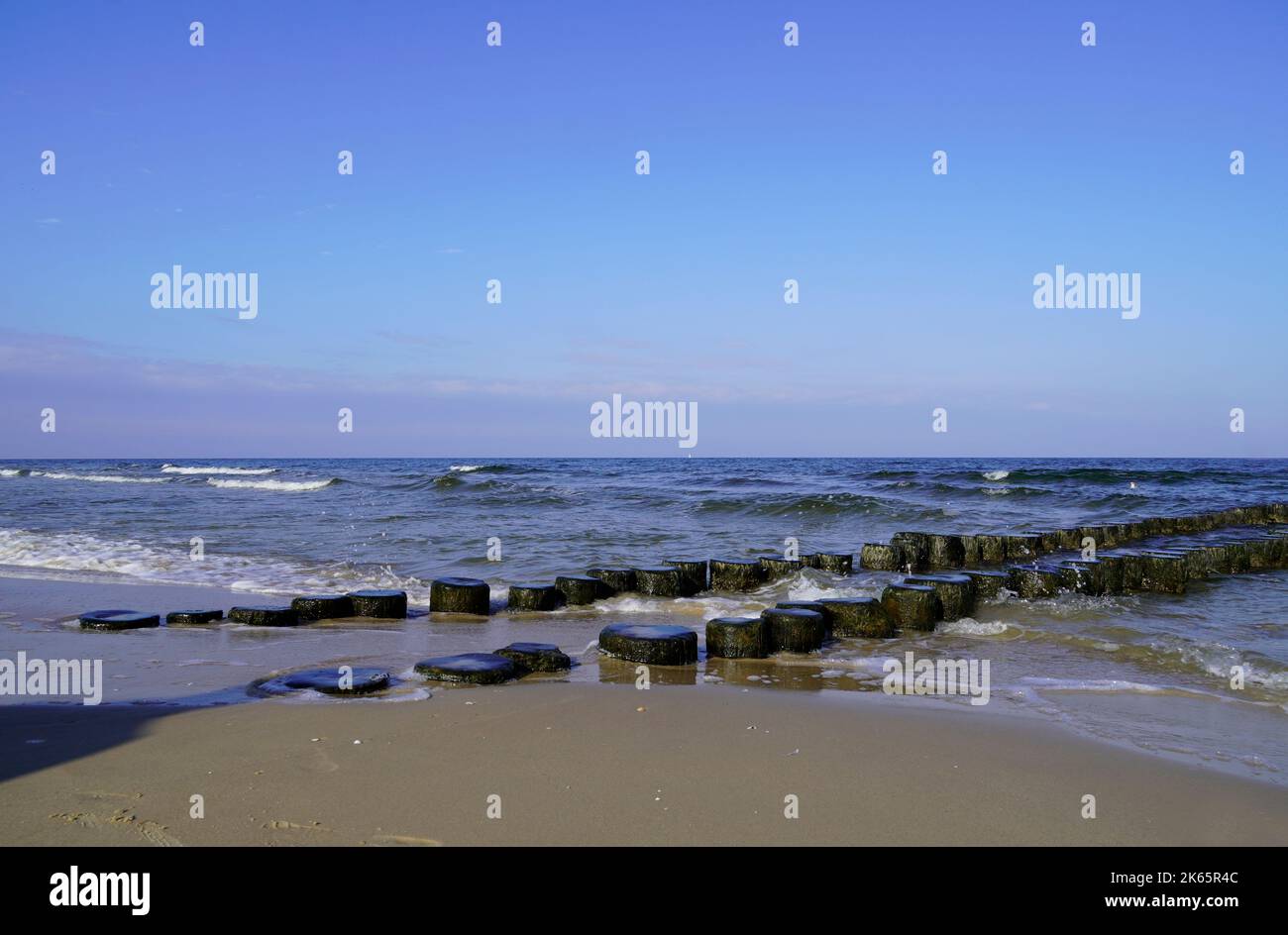 Costa baltica su Usedom con groynes di legno. Mar Baltico in serata. Foto Stock