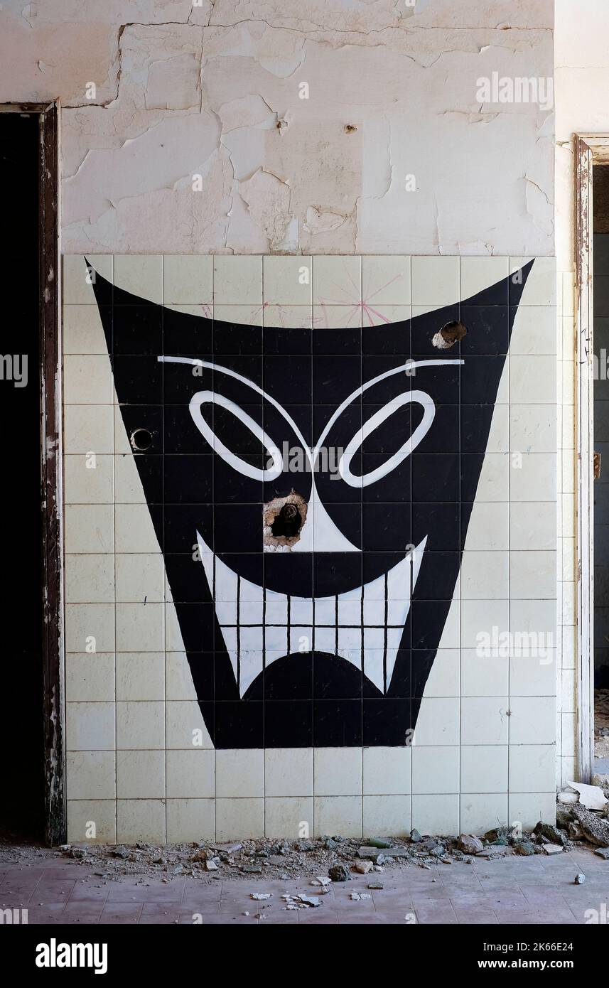 facciata graffiti su pareti piastrellate in un edificio deserto, puglia, italia Foto Stock