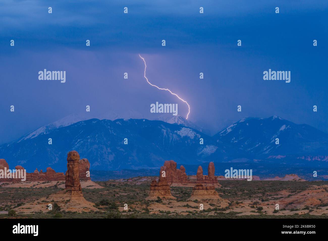 Fulmini che colpiscono una cima delle montagne la SAL, vista dal Parco Nazionale Arches, Moab, Utah. Foto Stock