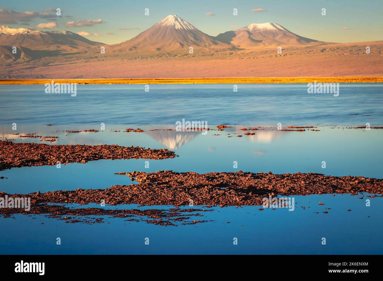 Paesaggio vulcanico e lago di sale riflessione al tramonto nel deserto di Atacama, Cile Foto Stock