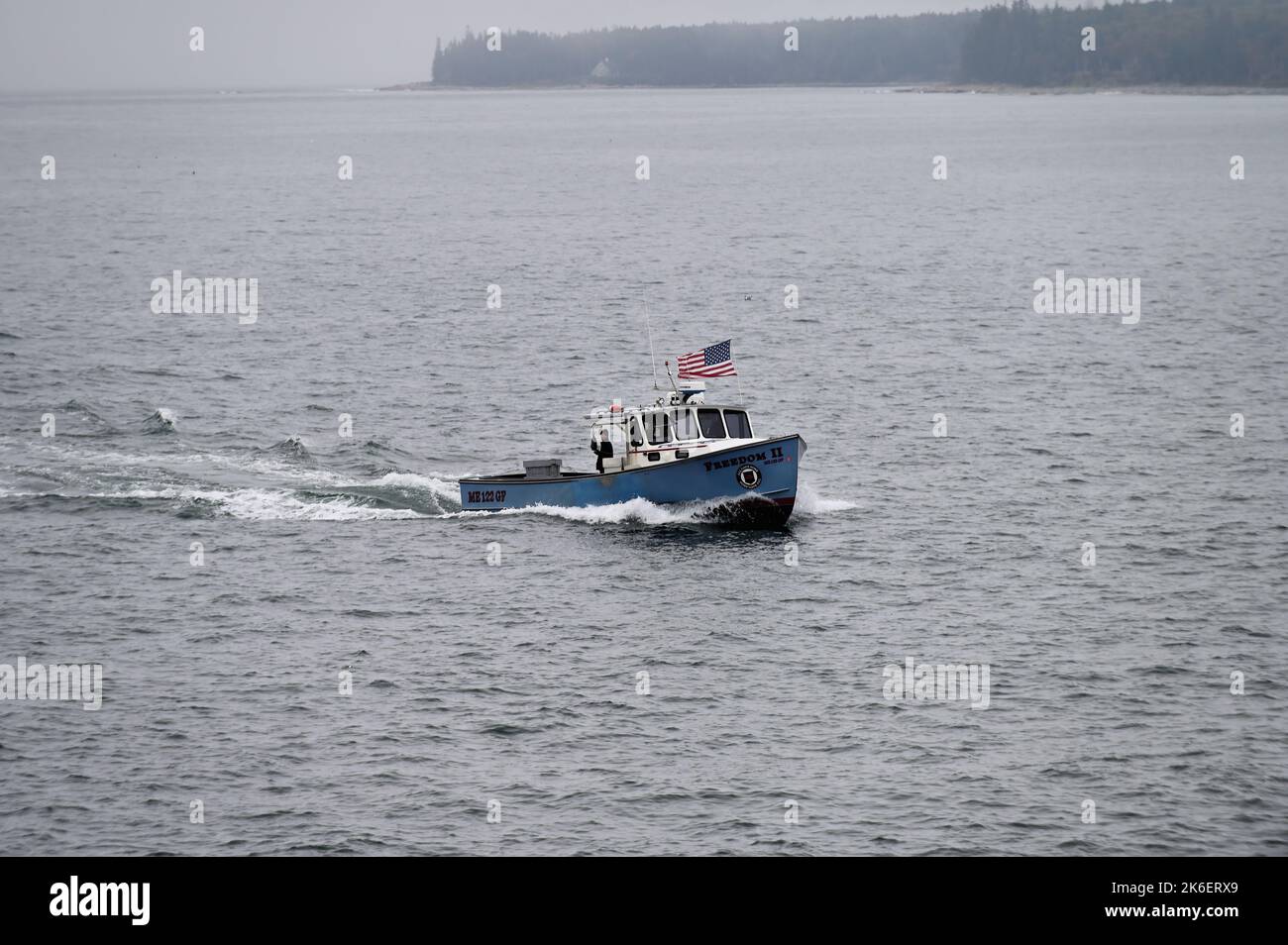 Acadia National Park, Maine, USA. Un'unica barca si dirige dalla distesa dell'Oceano Atlantico verso il rifugio sicuro di Bass Harbor. Foto Stock