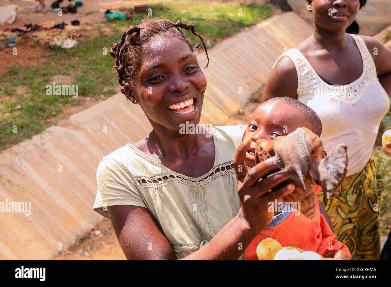 Accra, Ghana - 06 aprile 2022: Donna felice africana locale che vende i prodotti sulla strada del Ghana Foto Stock