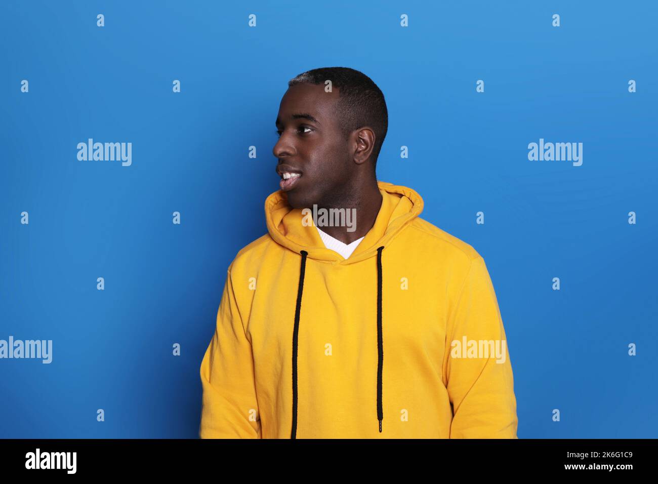 Allegro African American Guy sorridente su sfondo blu. Studio Shot of Happy Self-Confident Black Millennial Man che esprime emozioni positive Foto Stock