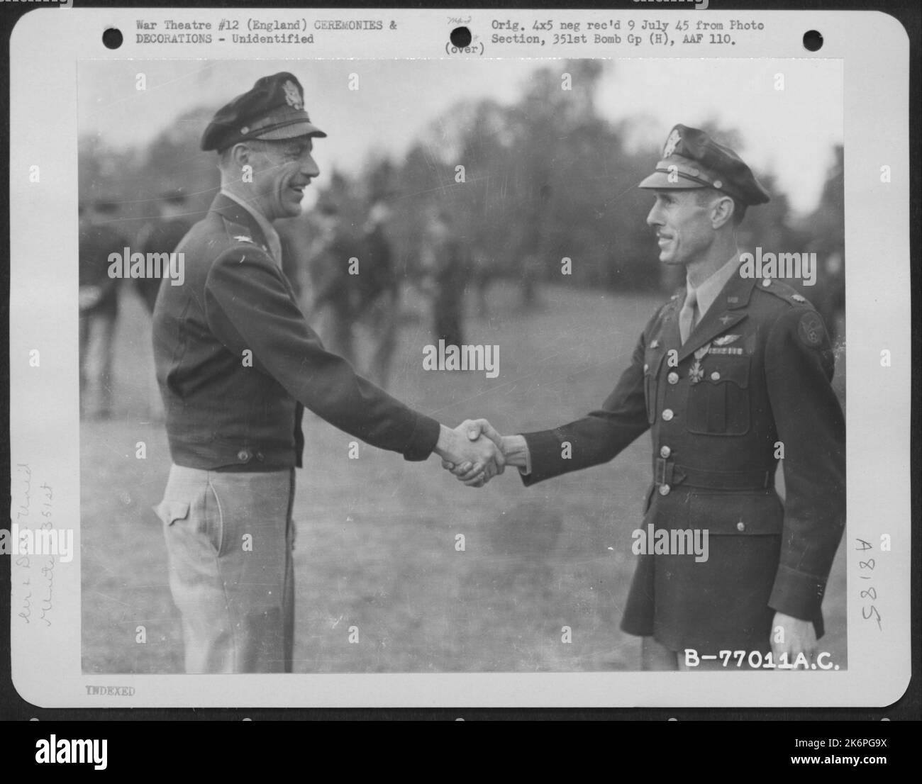 Un membro del 351st Bomb Group si congratula dopo aver ricevuto la Croix De Guerre durante Una cerimonia presso una base aerea in Inghilterra. 4 maggio 1945. Foto Stock
