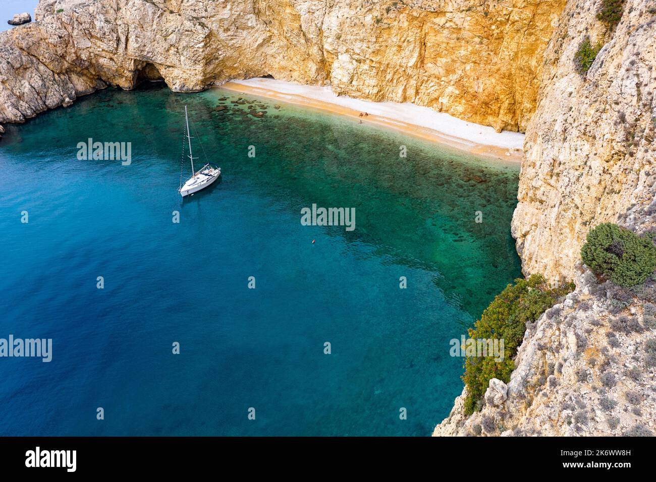 Barca a vela ancorata in una bella baia di spiaggia dorata vicino a Punat, Isola di Krk, Croazia Foto Stock