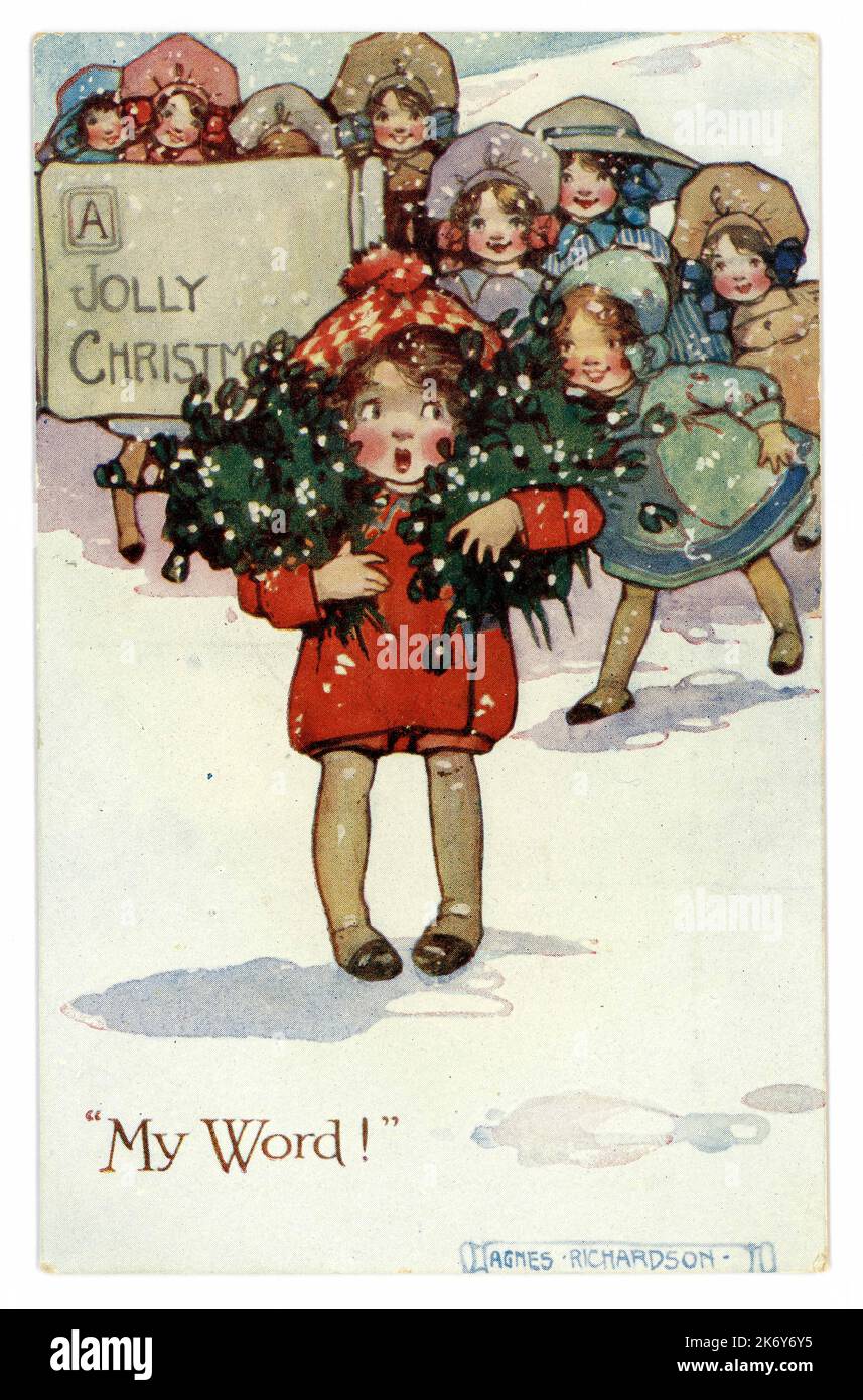 WW1 era carta di Natale della ragazza giovane che tiene un mazzo di mistletoe che dice 'la parola mite' e che augura un 'Natale jolly da Agnes Richardson. Circa 1915, Regno Unito Foto Stock