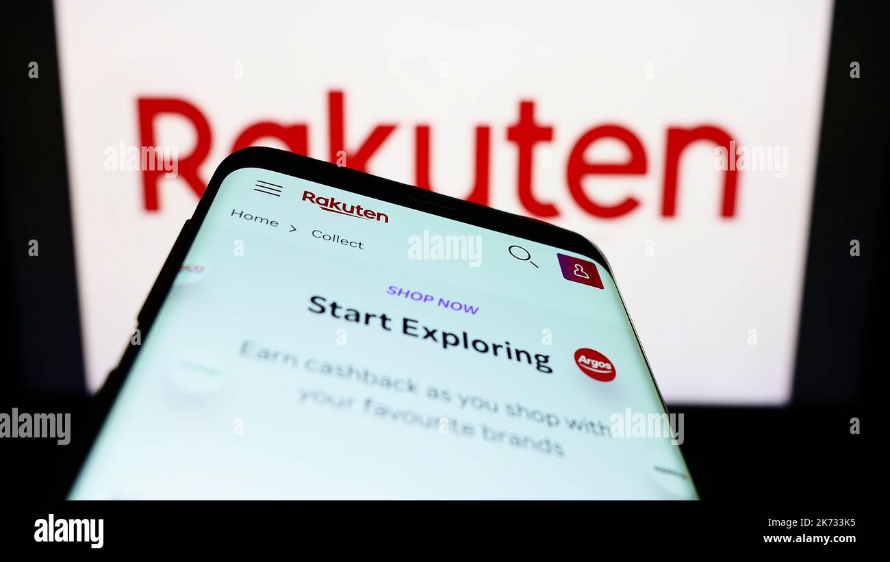 Telefono cellulare con sito web della società giapponese di e-commerce Rakuten Group Inc. Sullo schermo di fronte al logo. Messa a fuoco in alto a sinistra del display del telefono. Foto Stock