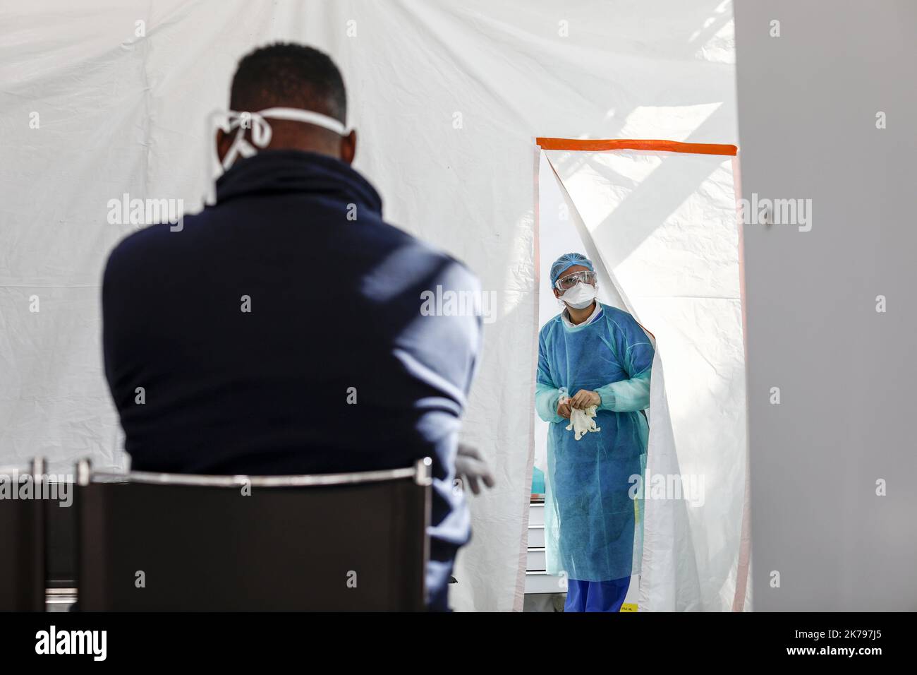 Un membro del personale ospedaliero indossa indumenti protettivi in una struttura per l'analisi del coronavirus Foto Stock