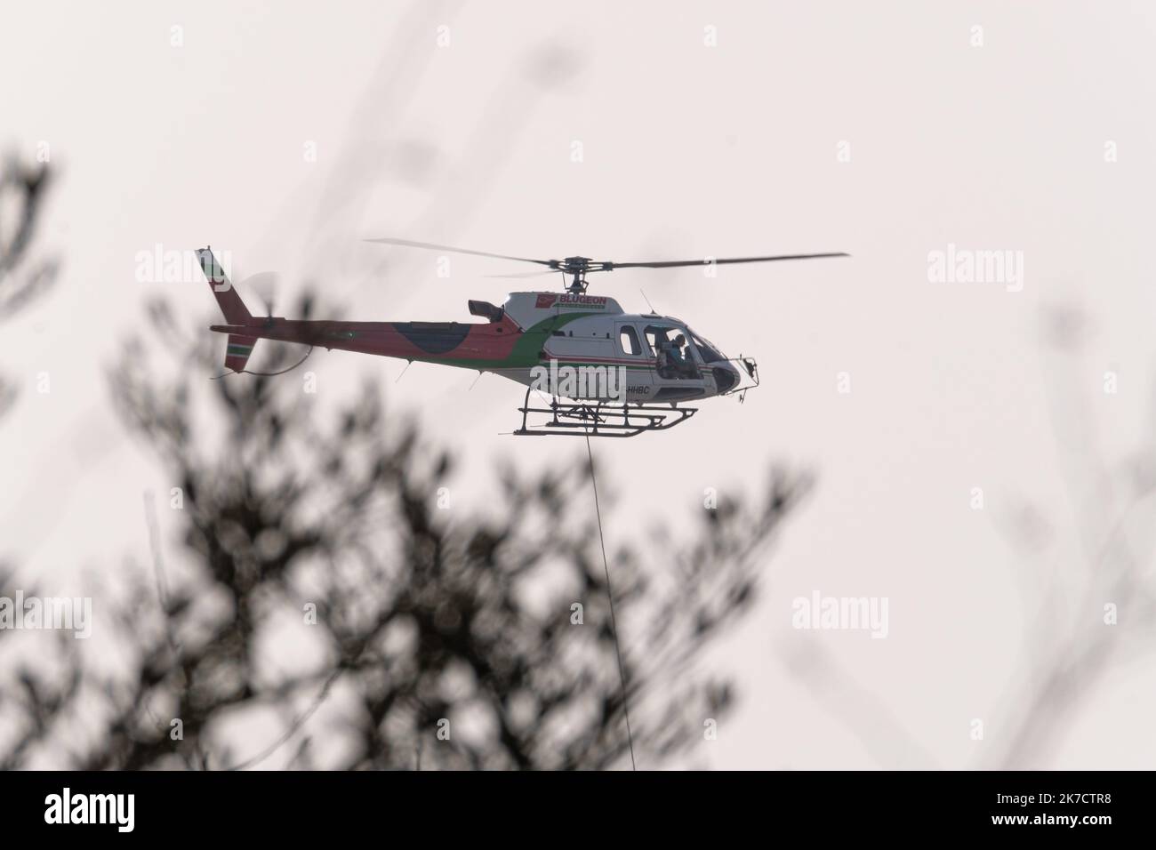 ©Arnaud BEINAT/Maxppp. 2021/02/24, Metz, Mosella, Francia. Un hélicoptère de la société Blugeon transporte des poutrelles métalliques a l'élingue pour la construction d'une tribune du stade de football Saint-Symphorien de Metz Foto Stock