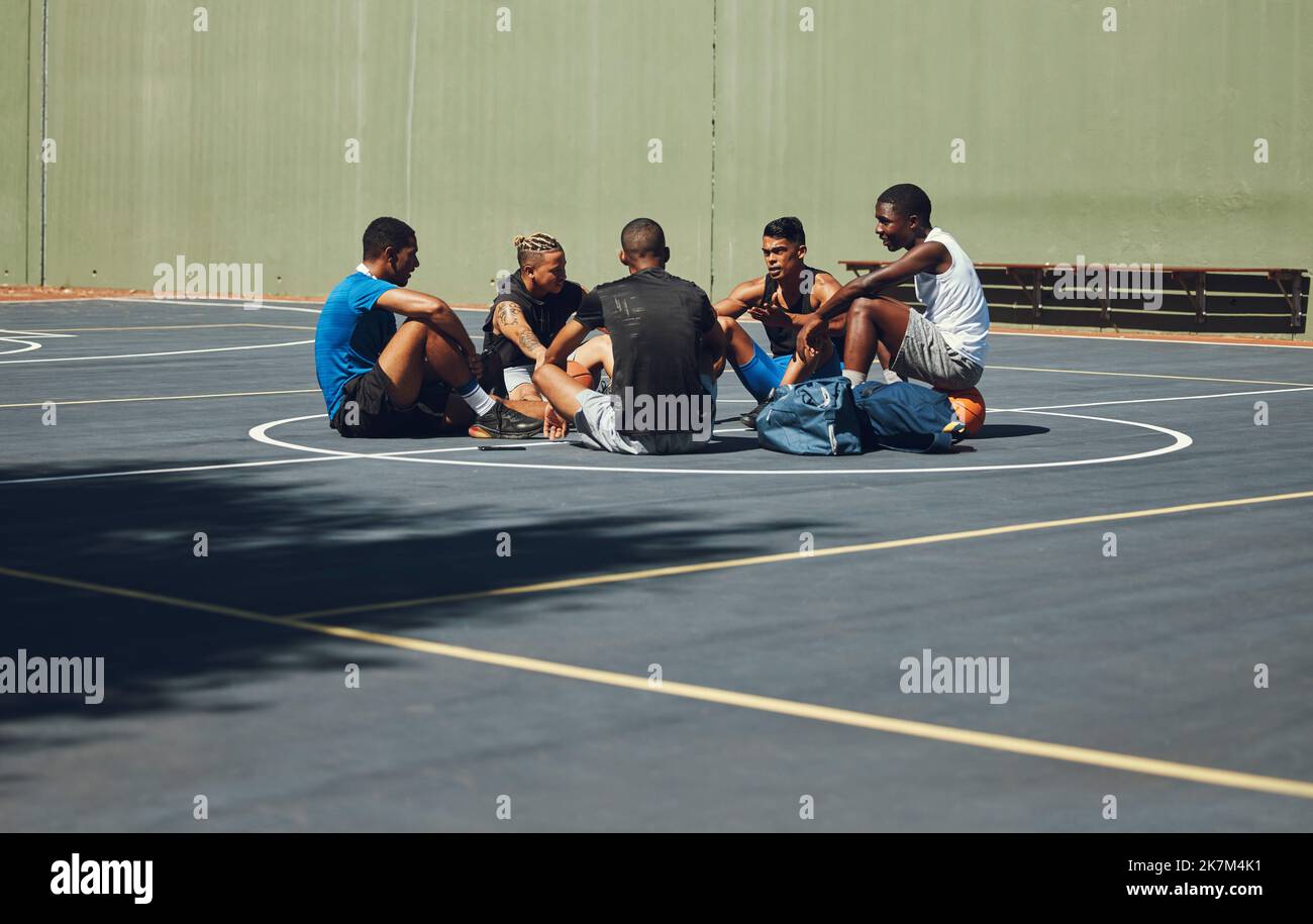 Lavoro di squadra, pallacanestro e pianificazione con gli amici rilassarsi sul campo sportivo per l'allenamento, l'allenamento e il fitness insieme. Esercizio fisico, obiettivi e salute con Foto Stock