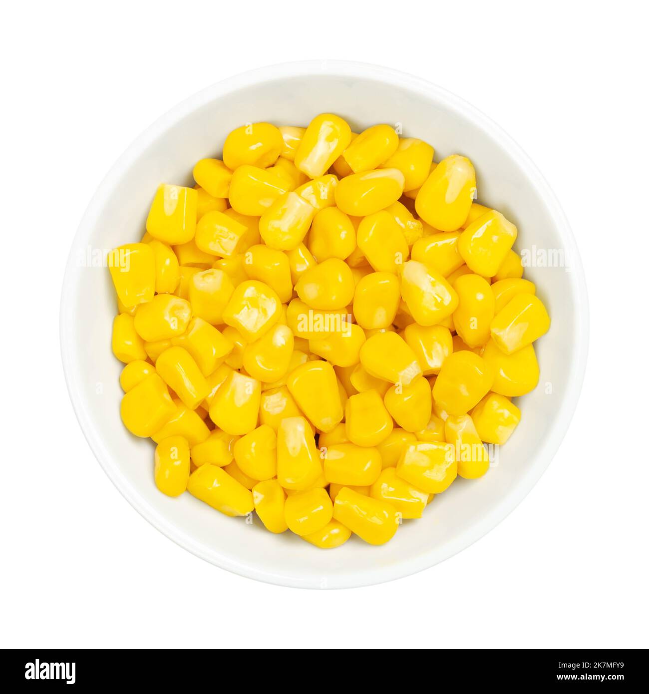 Chicchi di mais dolci, in una ciotola bianca su bianco. Mais vegetale giallo in scatola cotto, Zea mays, chiamato anche zucchero o mais palo. Foto Stock