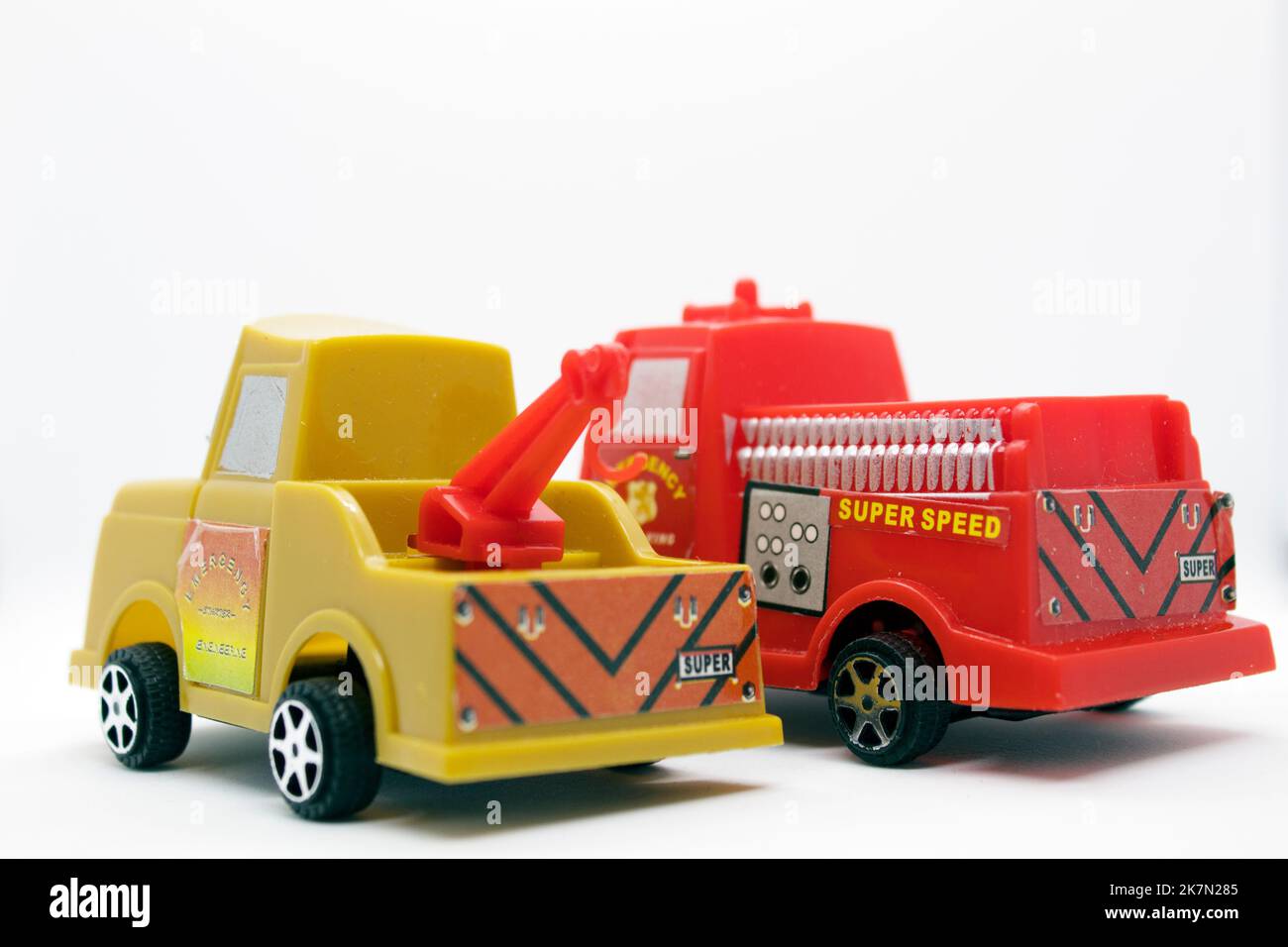 Camioncino dei pompieri e rimorchio giocattolo isolati su sfondo bianco con modelli di veicoli di emergenza e utilitari in plastica Foto Stock