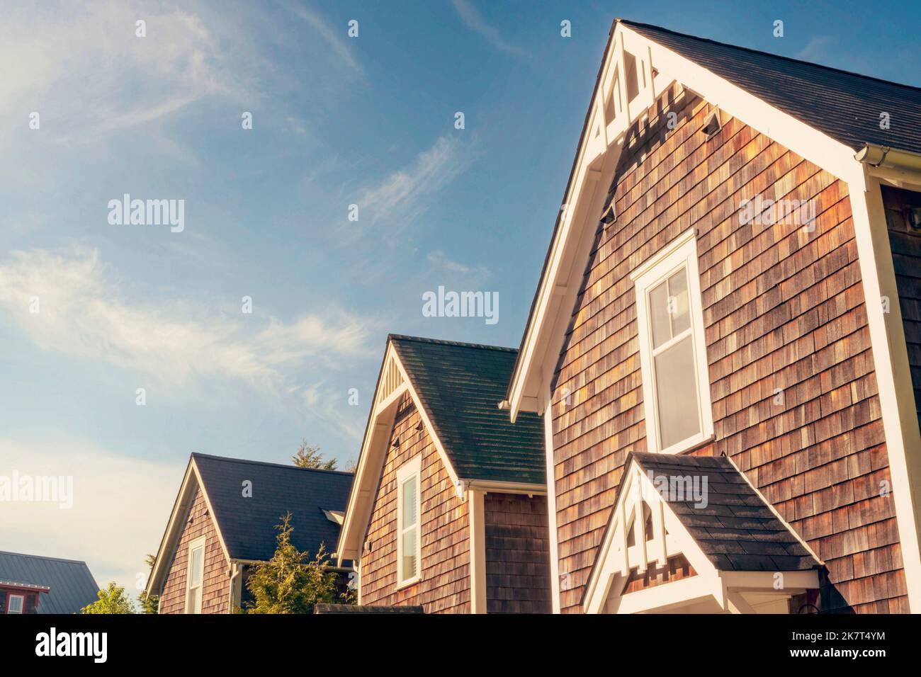 Tetti a picco di bianco-rifinito cottages di legno in ciottoli nella comunità di Seabrook, Stato di Washington, USA. Foto Stock