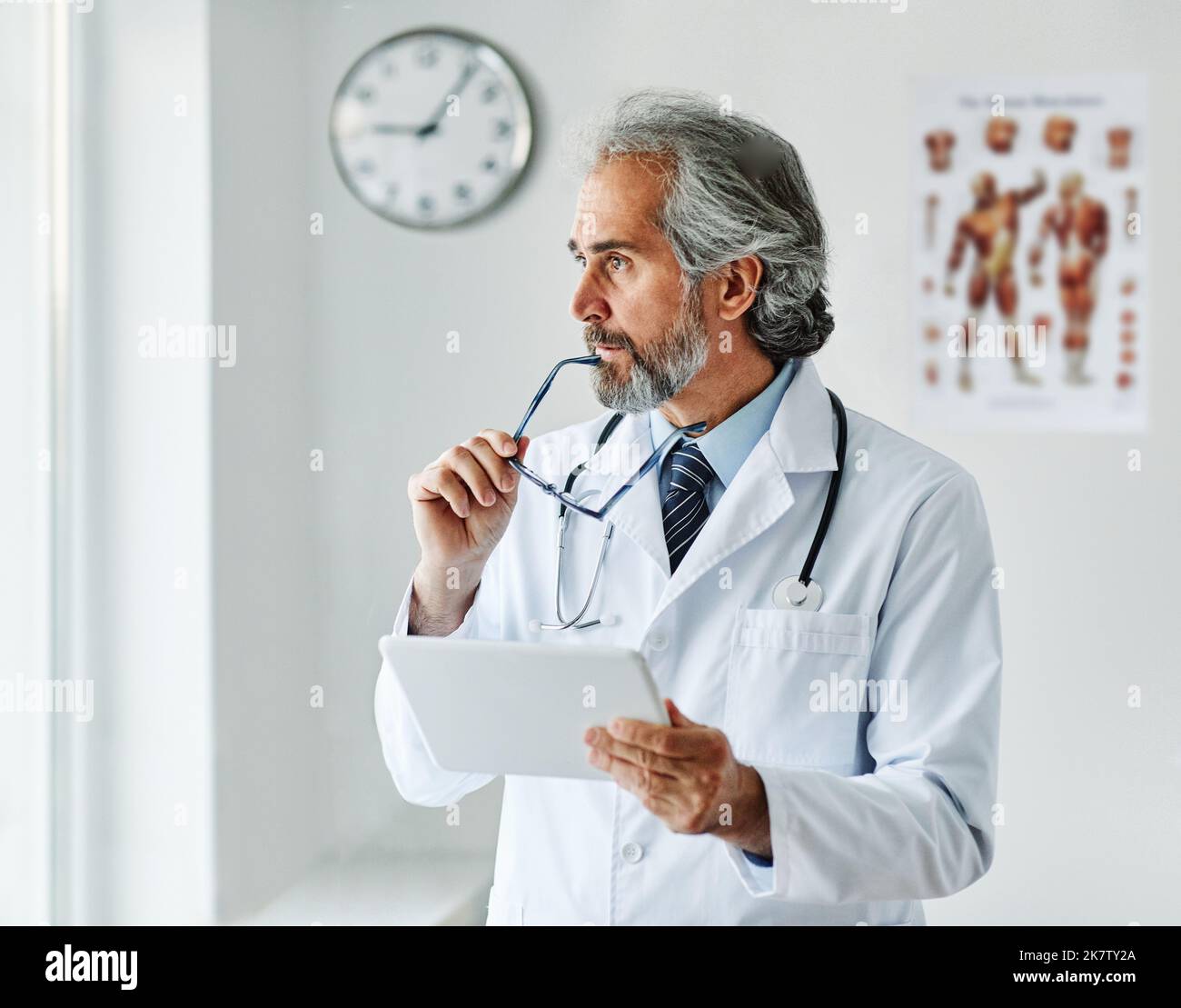 anziani capelli grigi attivi medico ospedale medicina salute clinica ufficio ritratto occhiali uomo stetoscopio specialista tablet computer Foto Stock