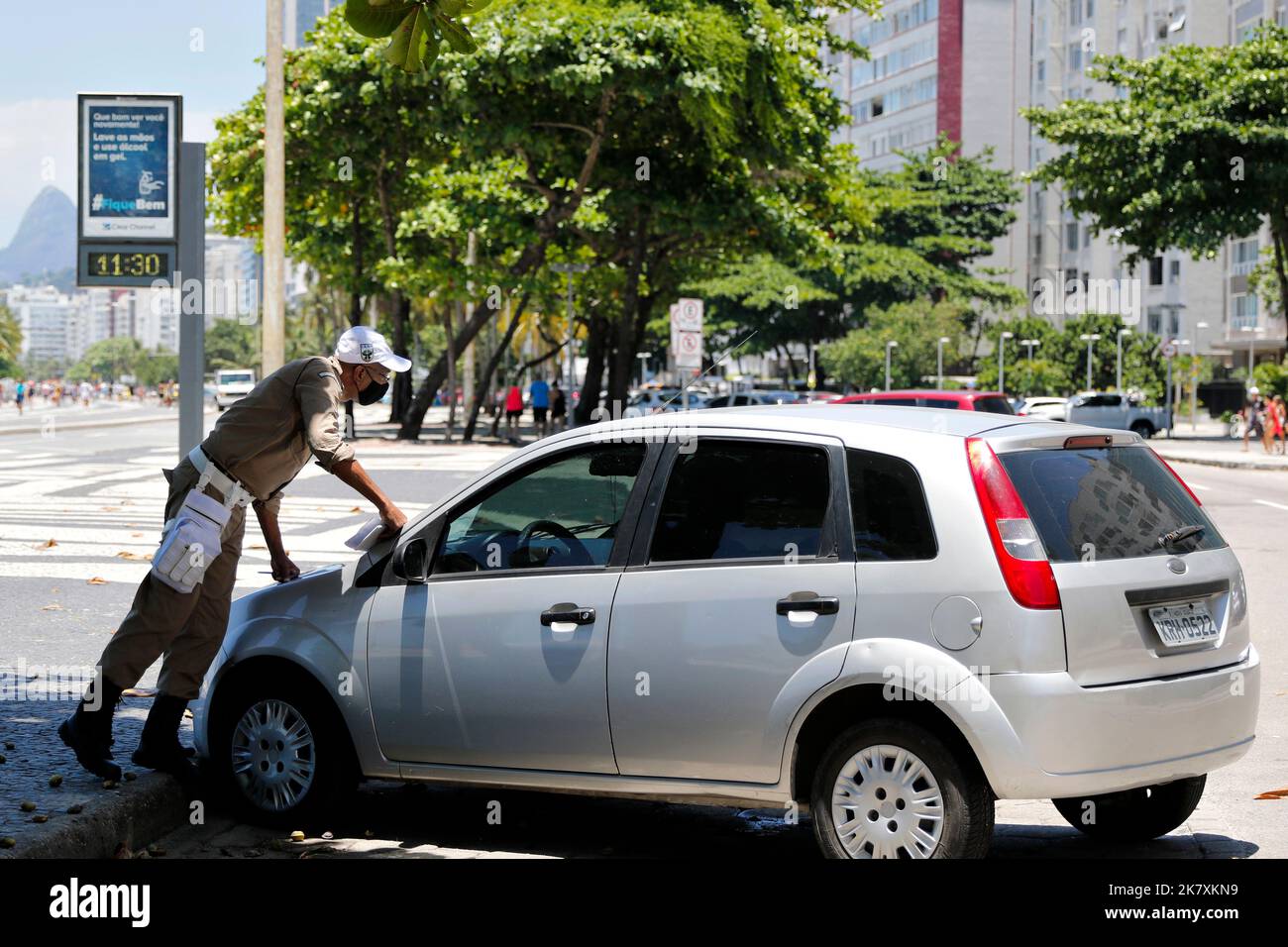 Poliziotto multa auto parcheggiata in modo improprio. Violazione del traffico Foto Stock