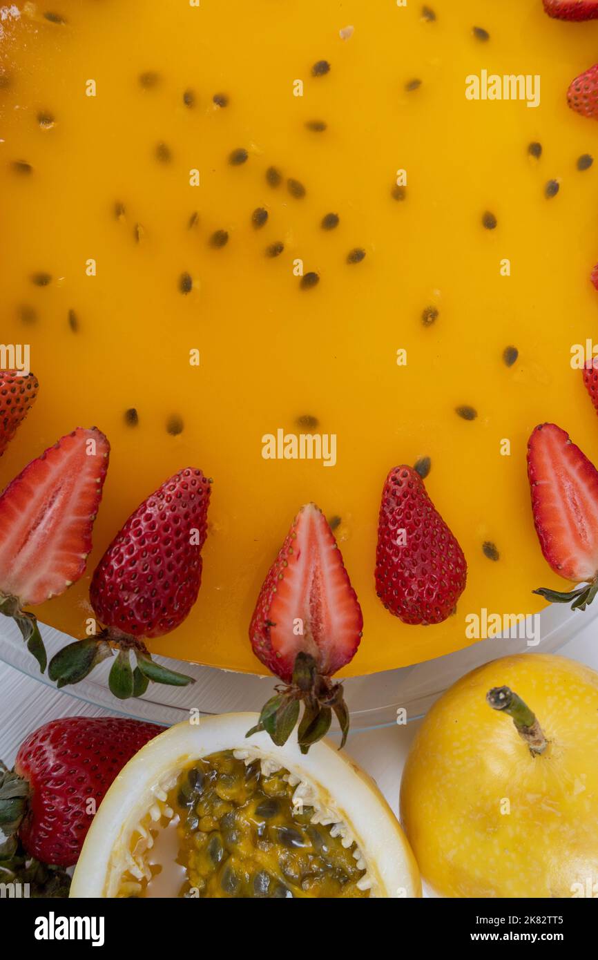 dettagli della consistenza della cheesecake, decorazione pasticceria in stile gourmet con frutto della passione, squisito cibo fresco in studio Foto Stock
