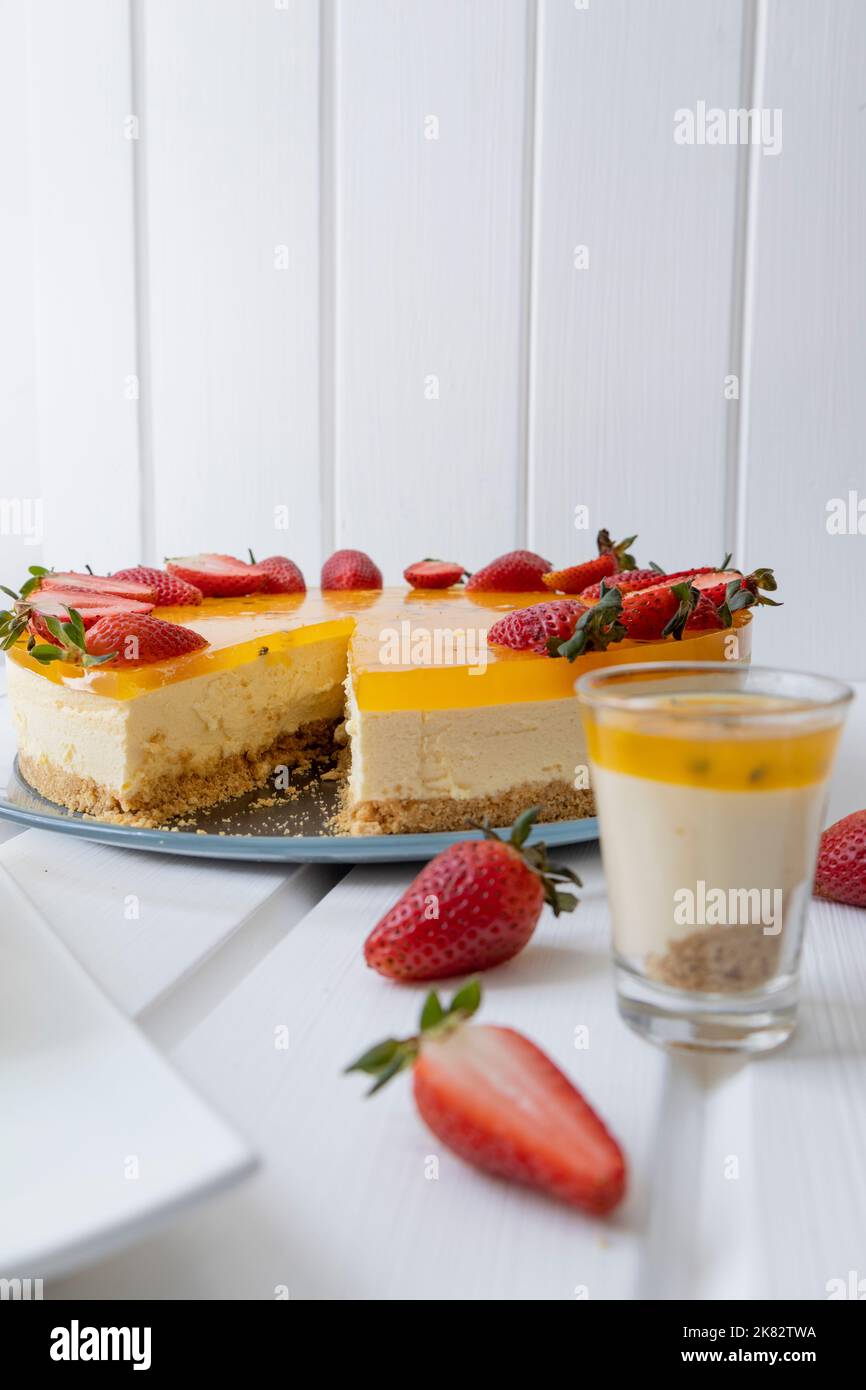 tagliare un pezzo di torta, pasticceria con frutto della passione servita su un piatto, squisito dolce, celebrazione Foto Stock