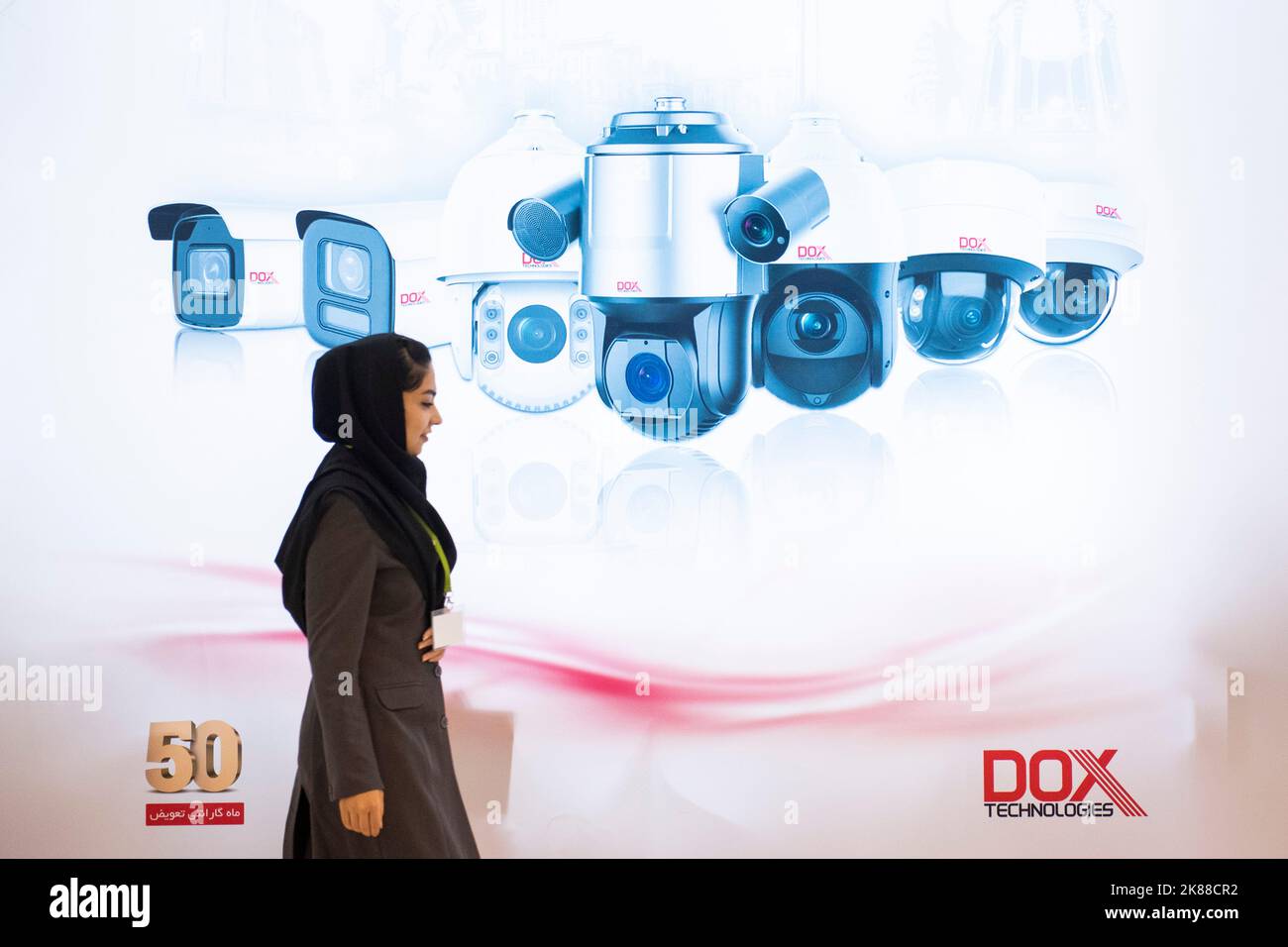 Teheran, Iran. 20th Ott 2022. Una donna passa davanti a un banner pubblicitario dell'azienda produttrice di telecamere IP Exsom, al diciannovesimo Salone internazionale delle apparecchiature per la sicurezza e la sicurezza della polizia (IPAS 2022) a Teheran, 20 ottobre 2022. (Foto di Sobhan Farajvan/Pacific Press/Sipa USA) Credit: Sipa USA/Alamy Live News Foto Stock