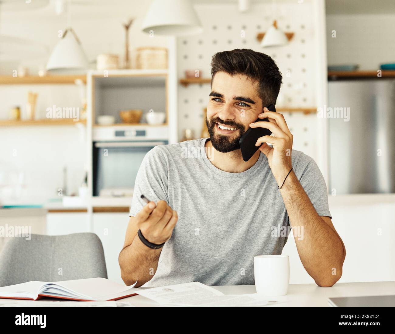 uomo telefono casa tecnologia comunicazione smartphone mobile chiamata ufficio adulto giovane impresa sorridente Foto Stock