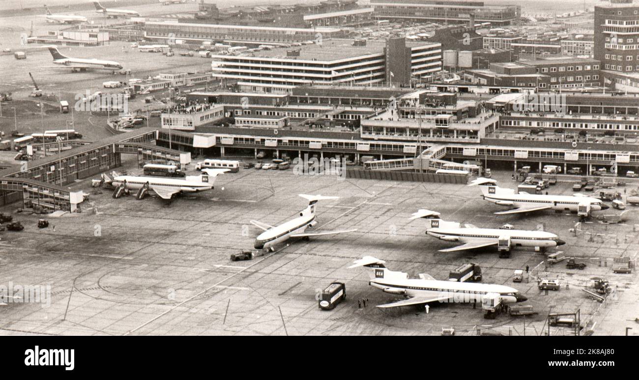 Vista dall'alto delle rampe di parcheggio dell'aeroporto Heathrow di Londra alla fine degli anni sessanta. È possibile identificare diversi tipi di compagnie aeree, in particolare alcune BEA Trident Three AT gate. Foto Stock