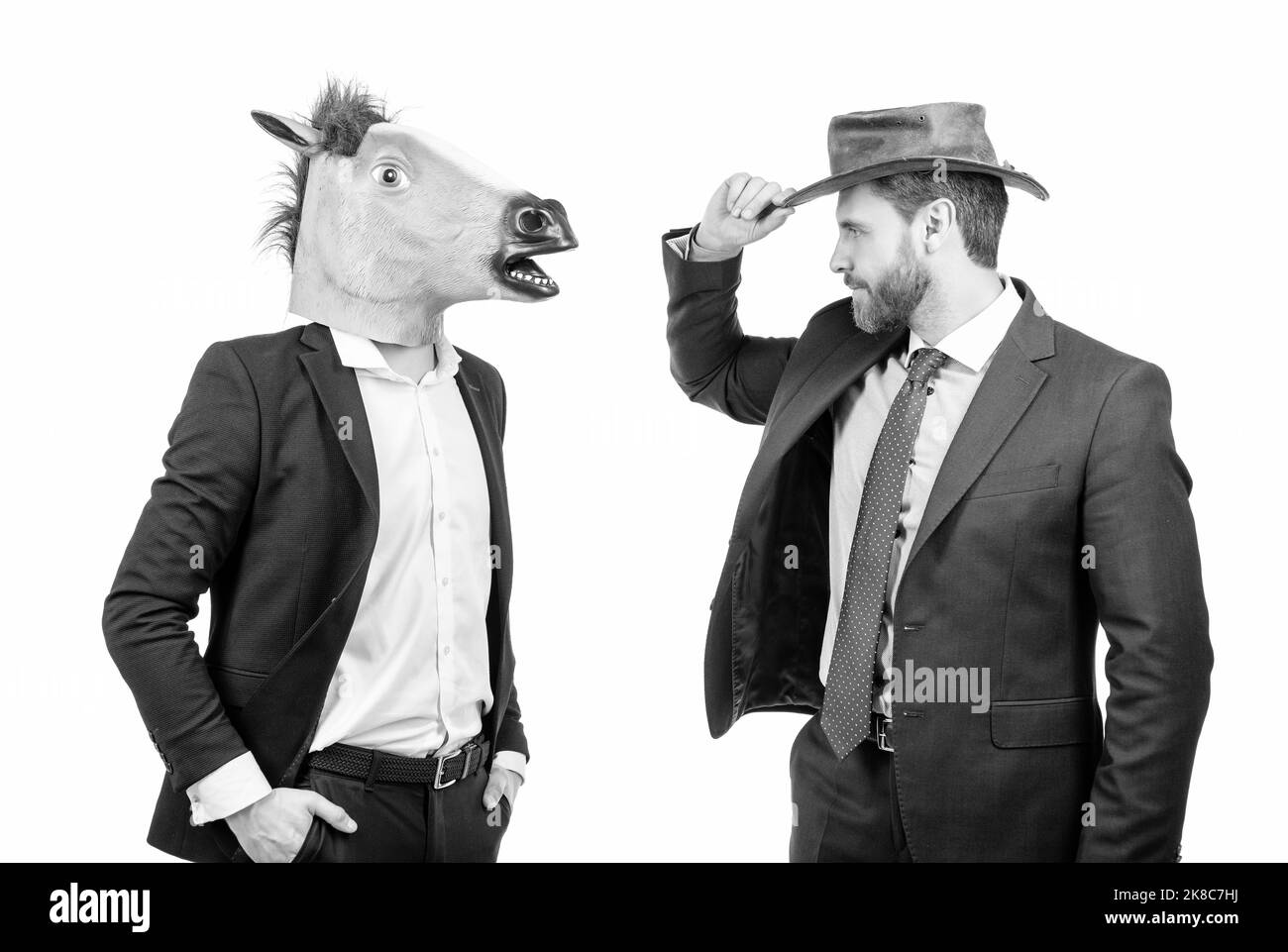 Uomo di cowboy e uomo d'affari in maschera testa di cavallo sul partito del costume, Halloween corporativo Foto Stock