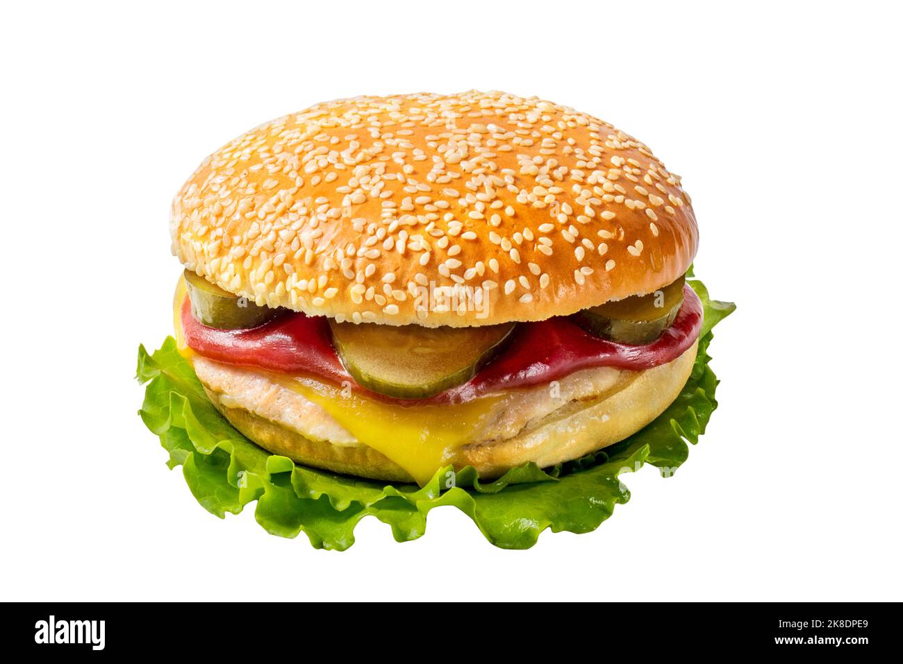 Cheeseburger alla griglia con sottaceti e salse in un panino bianco con semi di sesamo su una foglia di lattuga. Cibo di strada Foto Stock