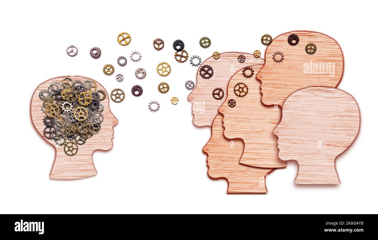 Concetto simbolo di formazione del lavoro di squadra e della leadership. Teste umane a forma di ingranaggi cervello idea fatta di legno che lavorano insieme come squadra in collaborazione di lavoro Foto Stock