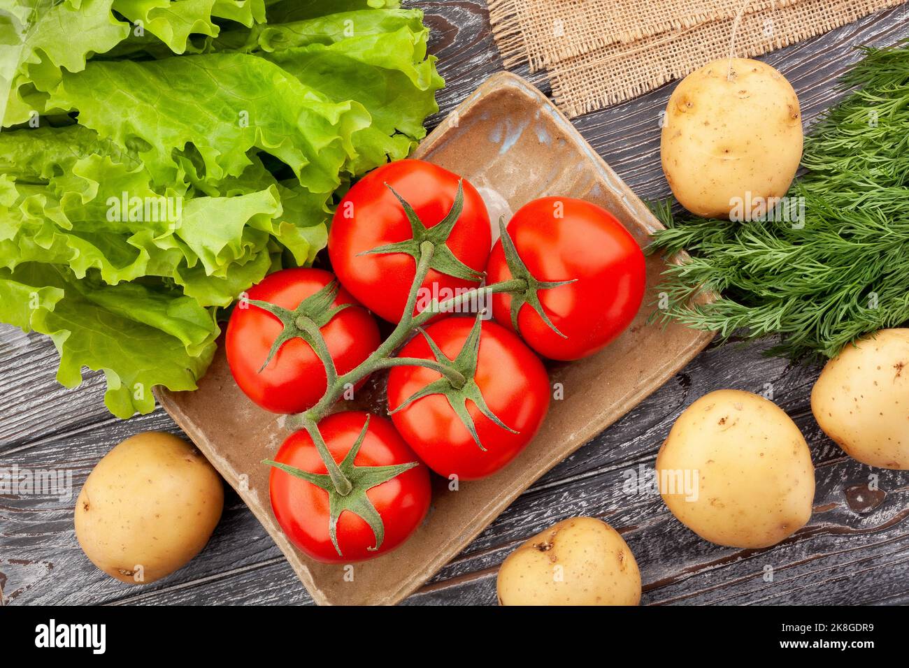 ramo di pomodoro su sfondo di legno Foto Stock