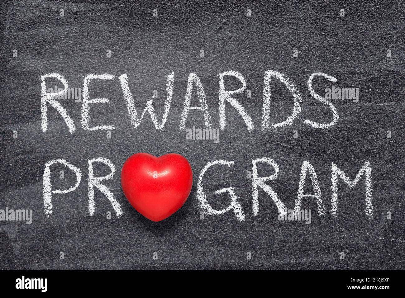 frase del programma rewards scritta sulla lavagna con il simbolo del cuore rosso Foto Stock