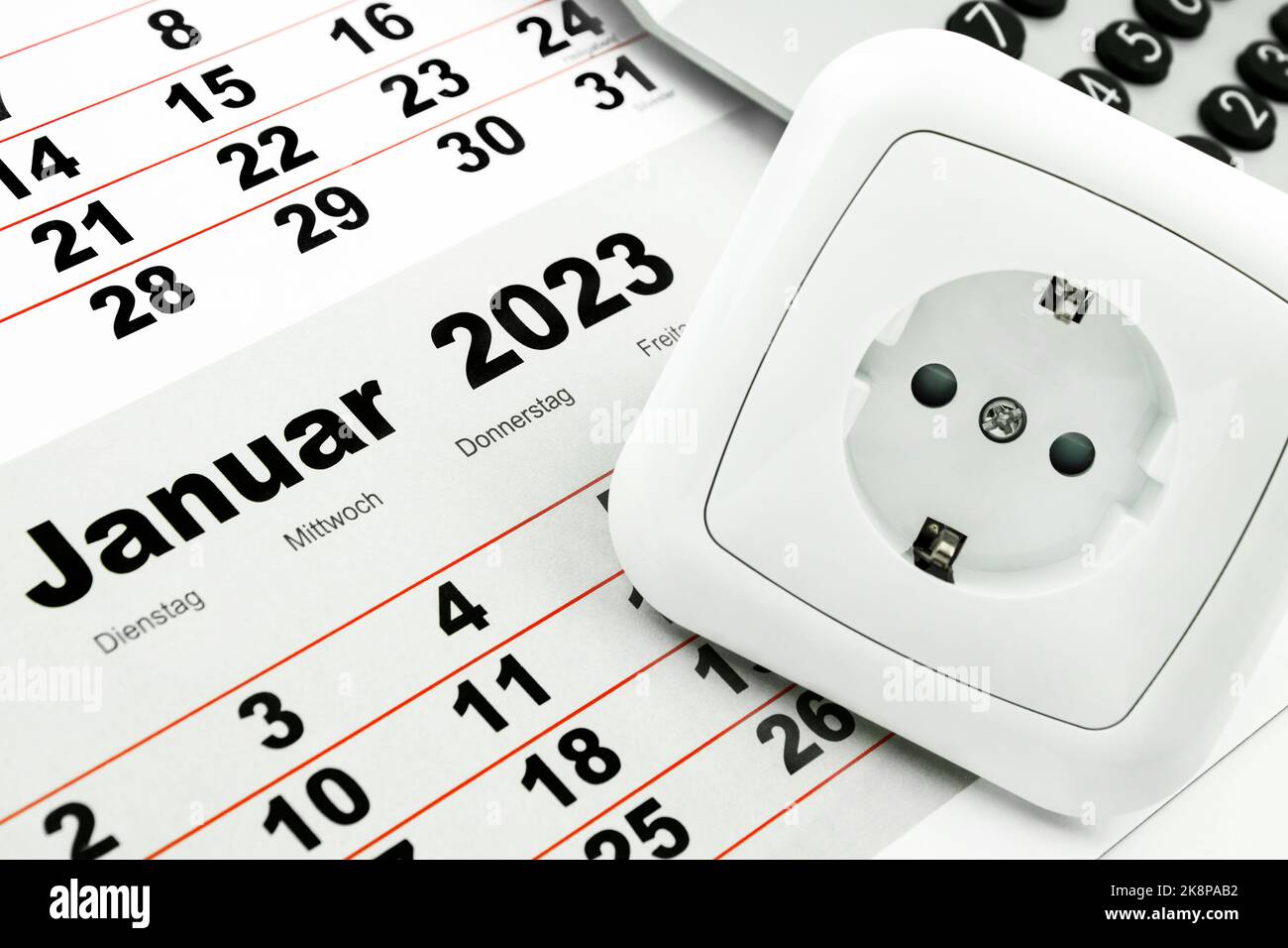 Deutscher Kalender Januar 2023 mit Steckdose und Rechner Energie und Kosten im Winter Foto Stock