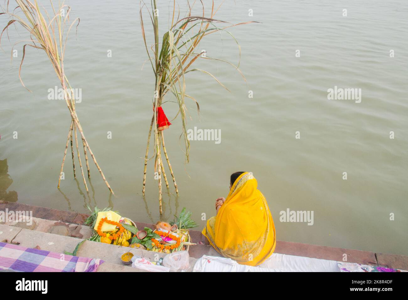 Uomini e donne indiane non identificati pregano e dedicano per il Chhath Puja festival sul lato del fiume Ganges a Varanasi, India. Foto Stock