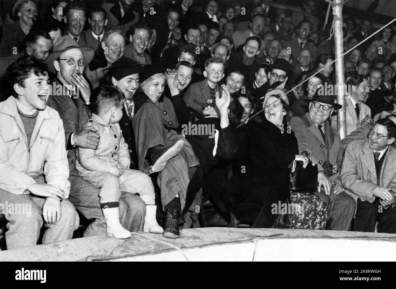 Oslo 1953; Circus Arnardo a Youngstorget nel centro di Oslo! Dopo l'apertura della stagione nella capitale, il trafficato circo visita 50 altrove in Norvegia, con Steinkjer come la fermata più a nord. Il pubblico è entusiasta dello strano capriccio dei clown musicali. Qui, uno di loro si è steso in grembo di una donna ridente. Foto; Aage Storløkken / corrente / NTB Foto Stock