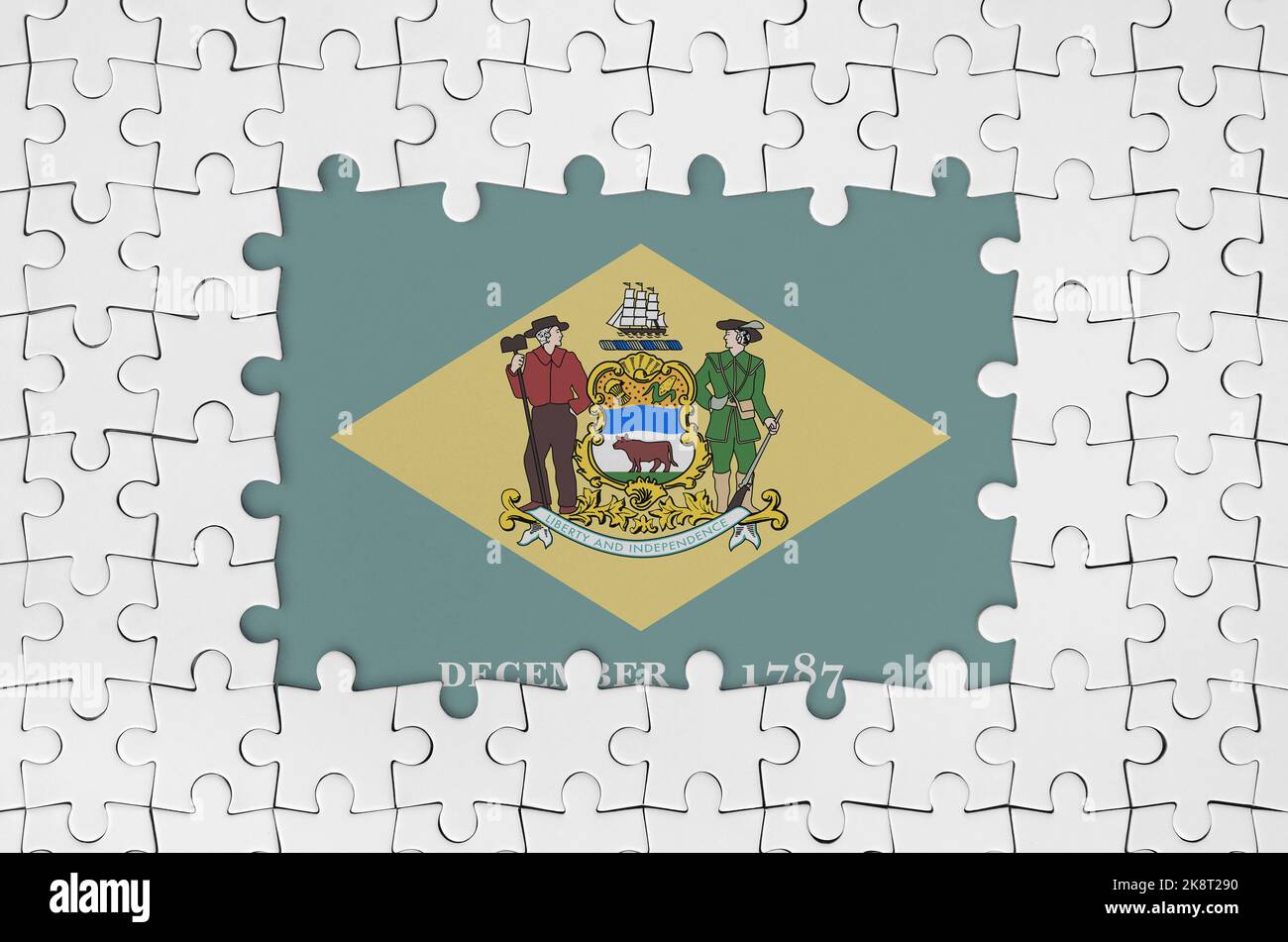 Bandiera degli Stati Uniti Delaware in cornice di pezzi di puzzle bianchi con parti centrali mancanti Foto Stock