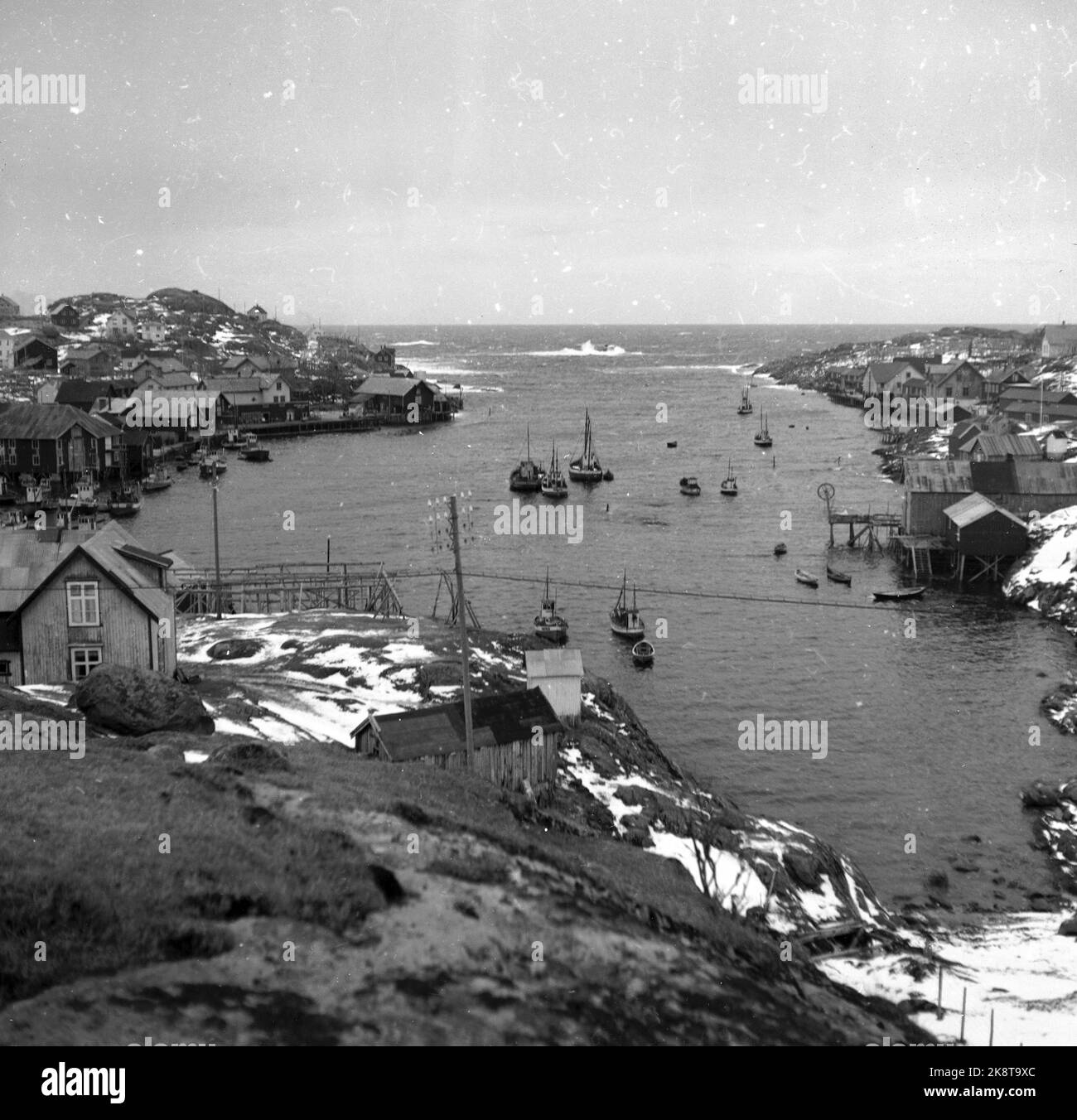 Lofoten nell'inverno del 1951. Diversi villaggi di pescatori a Lofoten sono abbandonati perché sono impossibili da operare senza elettricità, strada, banchina e connessione telefonica. In alcuni luoghi, i comuni hanno chiesto di spostare denaro dallo stato per spostare l'intera popolazione, comprese le case abitative. Qui a Sørvågen ha una gran parte della popolazione trasferita. Il porto di Sørvågen è caldo e ben protetto. Neve in aria. Foto: Sverre A. Børretzen / corrente / NTB Foto Stock
