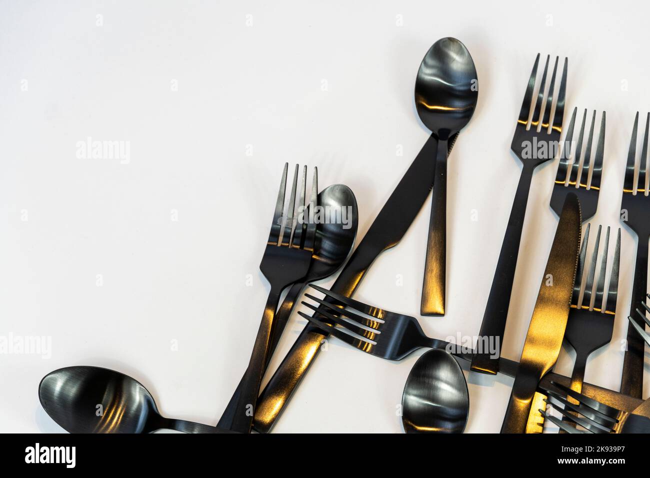 Metallo nero Dinnerware utensili da cucina, Forks coltelli, cucchiai su sfondo grigio mexcio Foto Stock