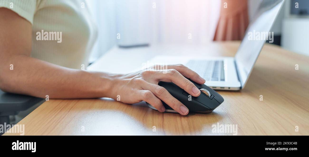 Donna che usa un mouse verticale ergonomico durante il lavoro sulla  scrivania regolabile, per prevenire il dolore al polso. Tenosinovite de  Quervain, sintomo di intersezione Foto stock - Alamy